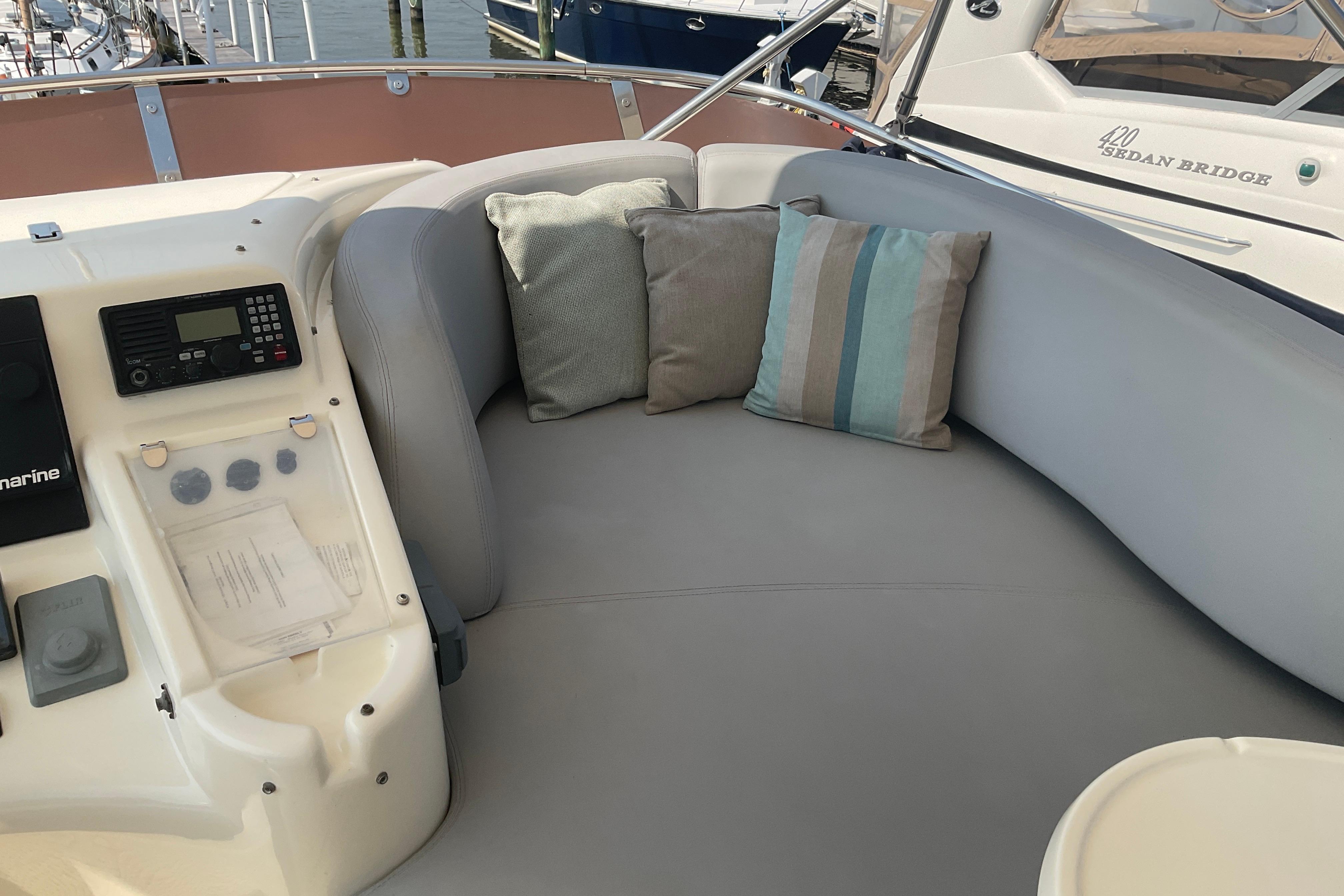 Luxurious seating area on 2005 Azimut Fly 50 yacht with cushions and control panel.