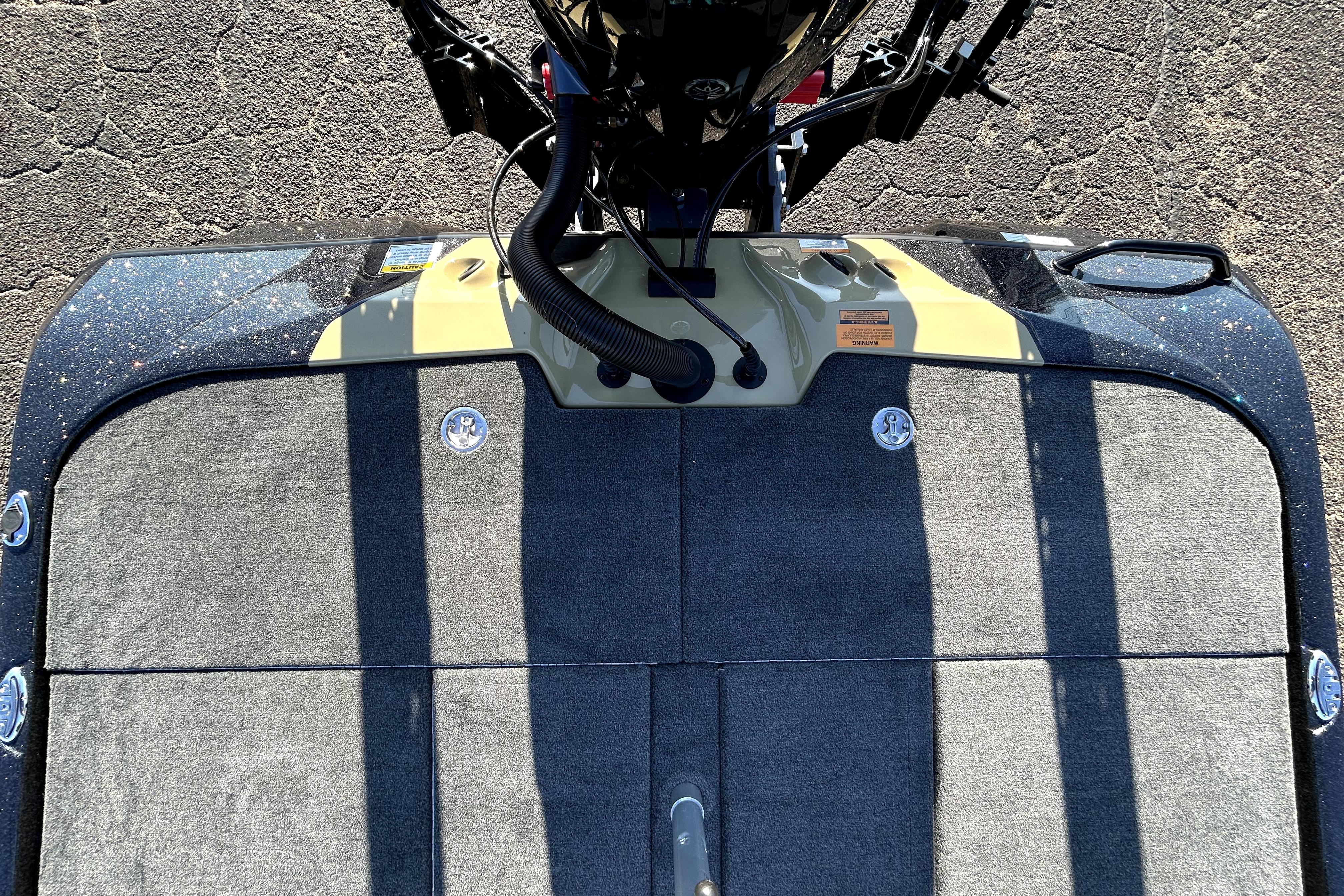 Top view of 2026 Skeeter ZXE21 boat deck with motor and carpeted surface.