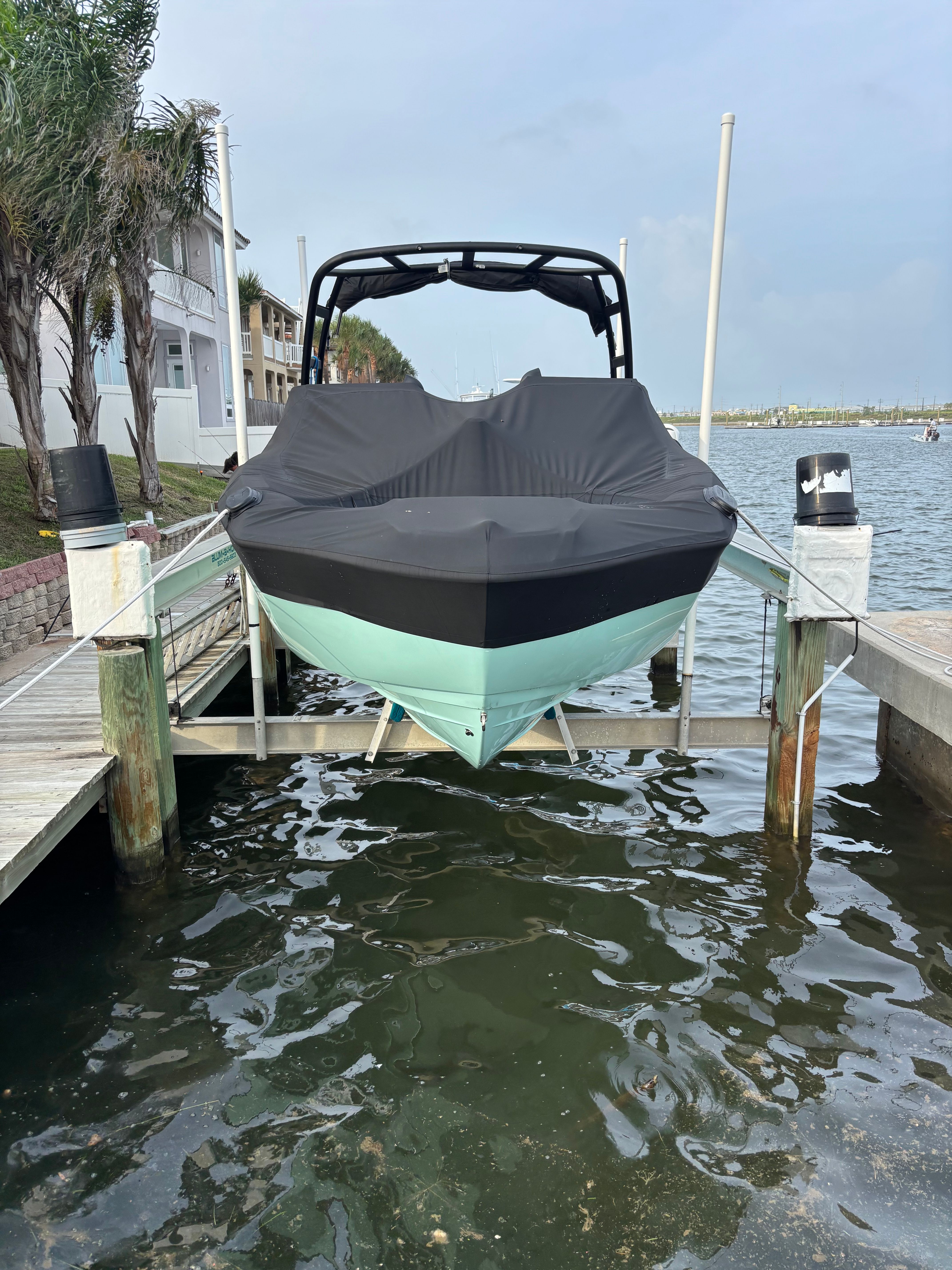 A 2024 Yamaha AR250 boat on a lift by the water.