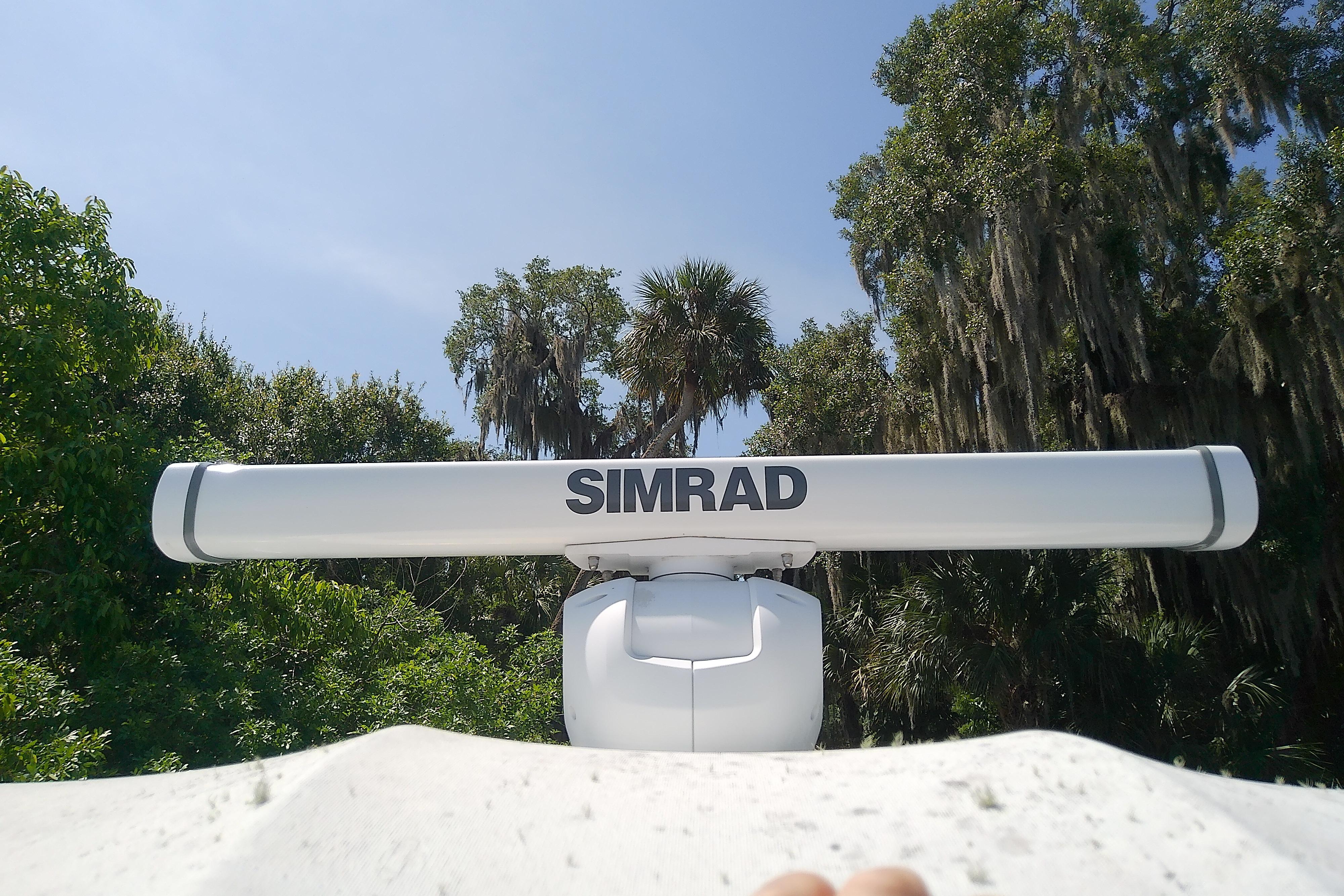 Simrad radar on 2000 Tiara Yachts 4100 Open, surrounded by lush greenery.