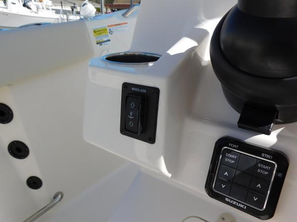 Control panel of 2024 Sailfish 242 CC boat with winch and engine start/stop buttons.