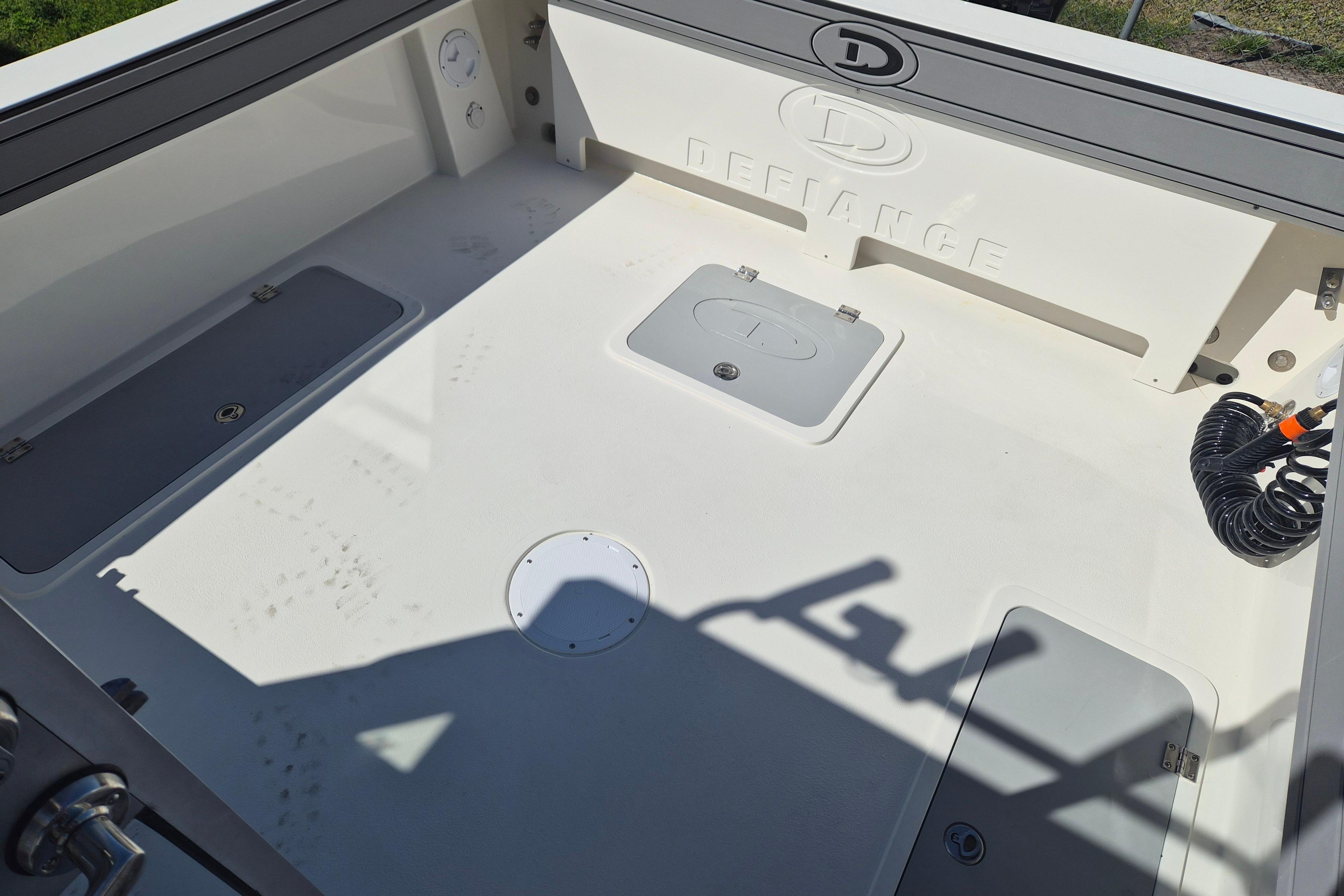 2026 Defiance Admiral 220 EX boat deck with storage compartments and coiled hose.