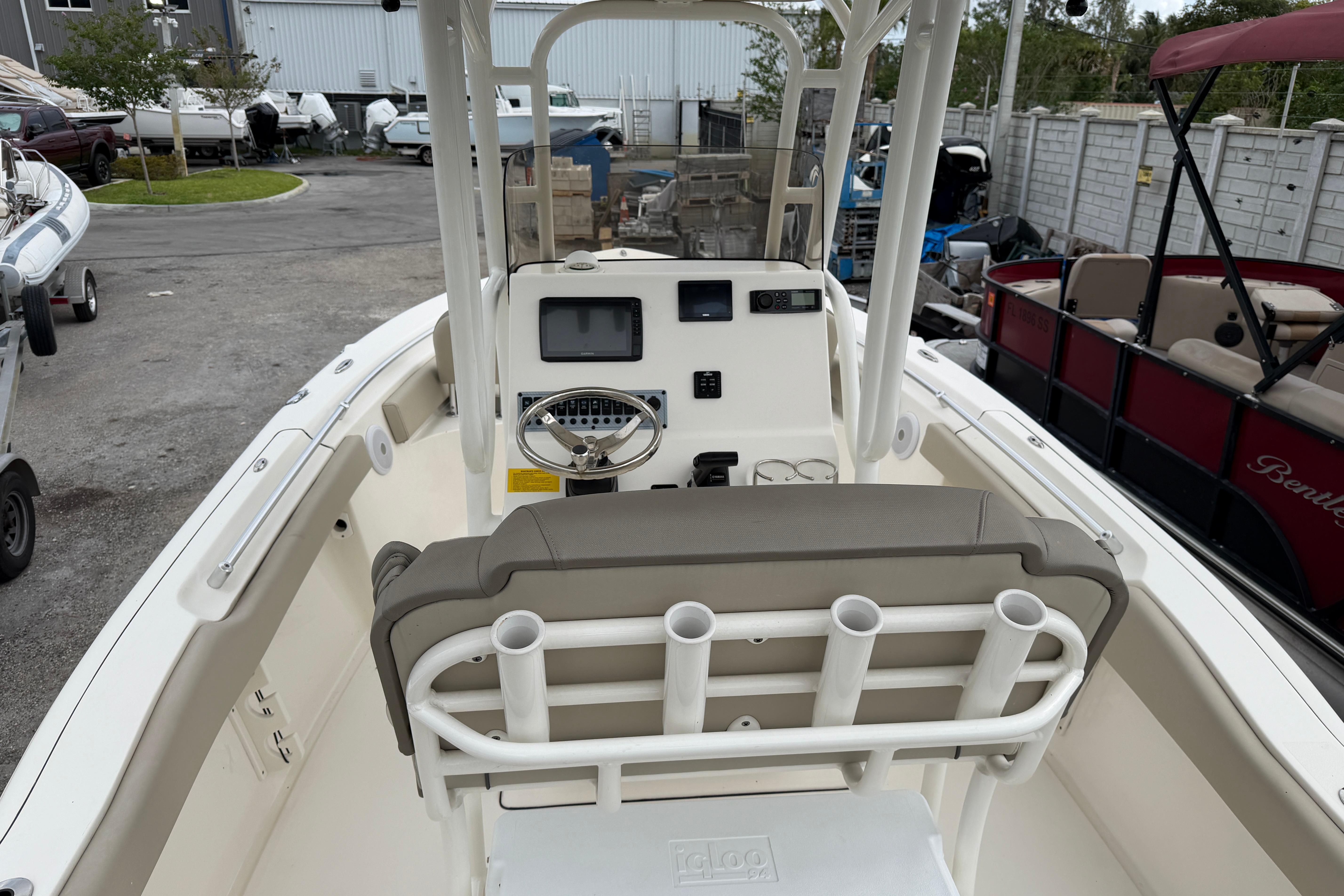 2022 Key West 219 FS boat interior with helm, seating, and rod holders.
