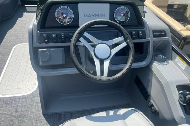 2026 Godfrey Sweetwater 2286 SBC boat dashboard with Garmin navigation system and steering wheel.