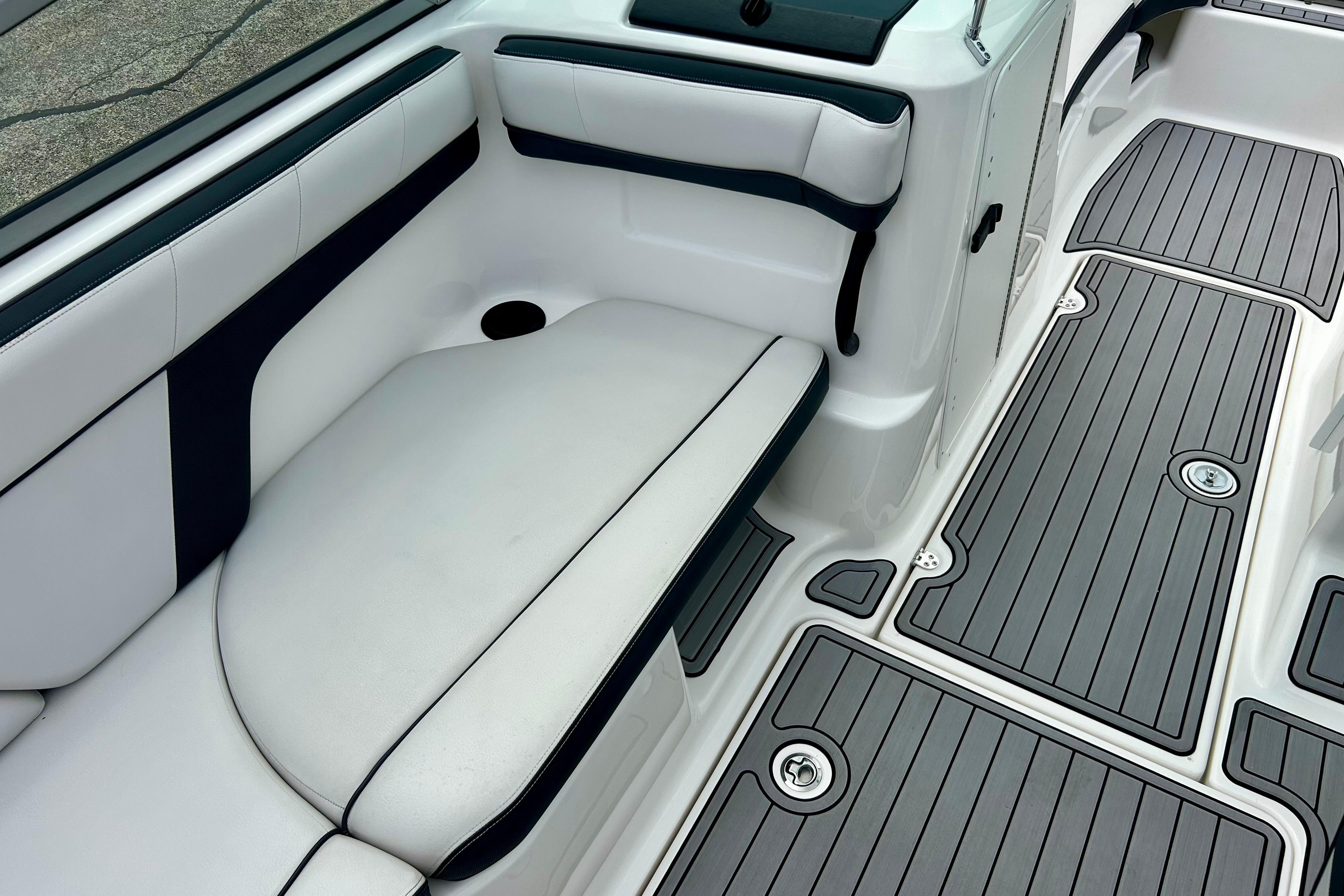 2015 Yamaha AR210 boat interior with cushioned seating and sleek flooring design.