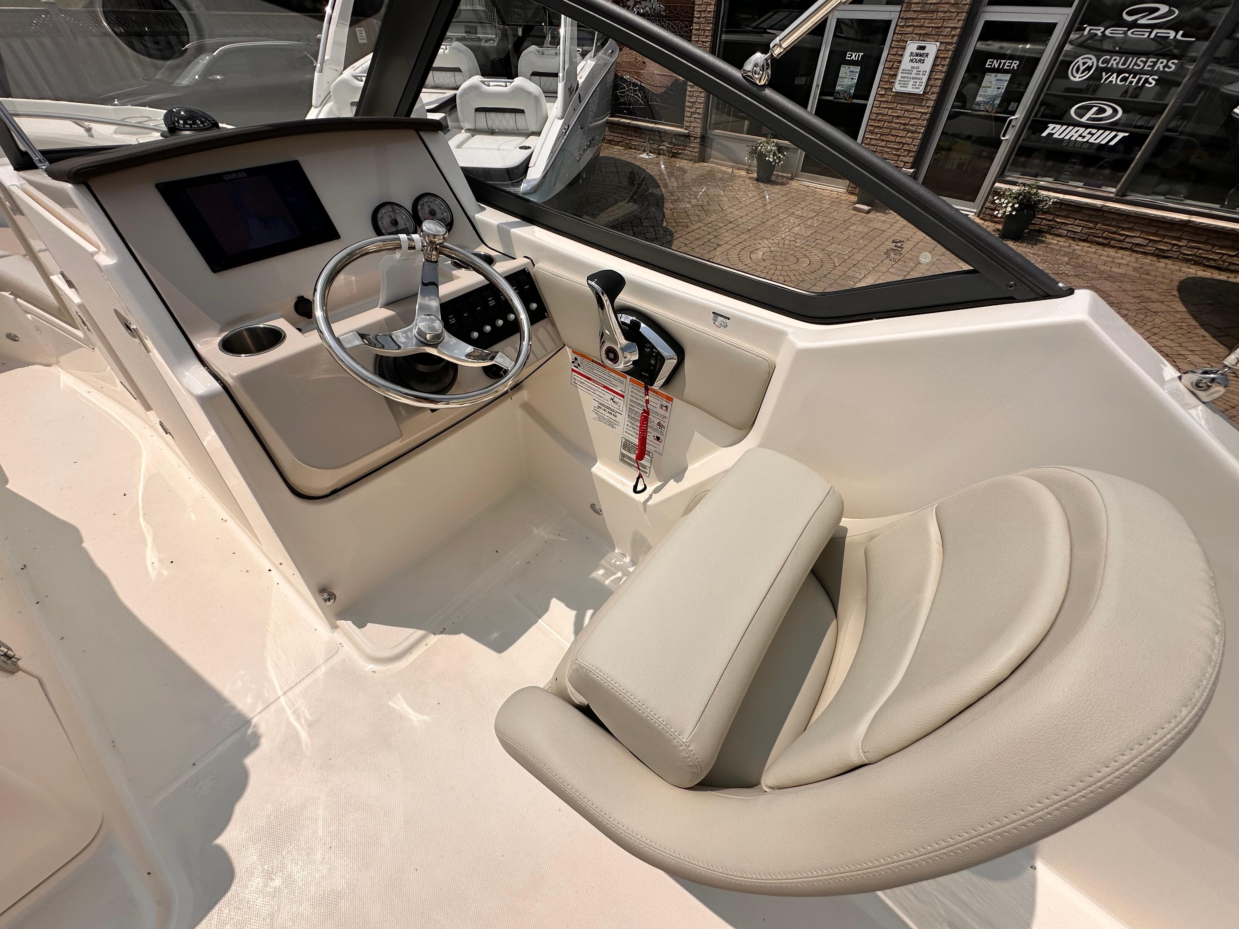 2025 Boston Whaler 210 Vantage boat interior with steering wheel and control panel.