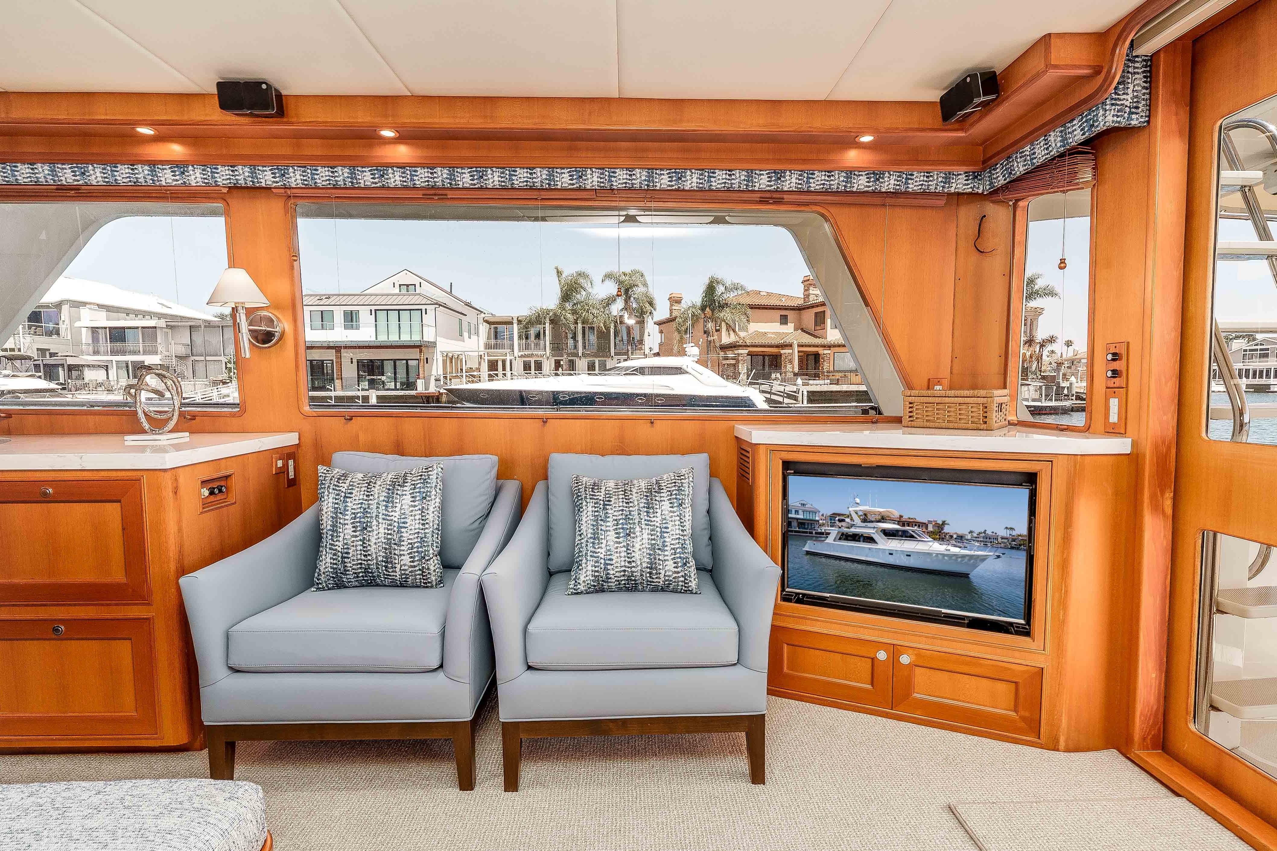Luxurious interior of 2005 Offshore Yachts 54 Pilothouse with elegant seating and waterfront view.