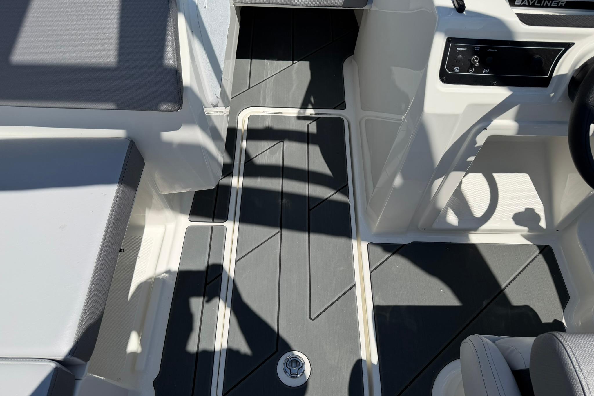 Interior view of 2026 Bayliner D20 boat, featuring sleek seating and modern dashboard.