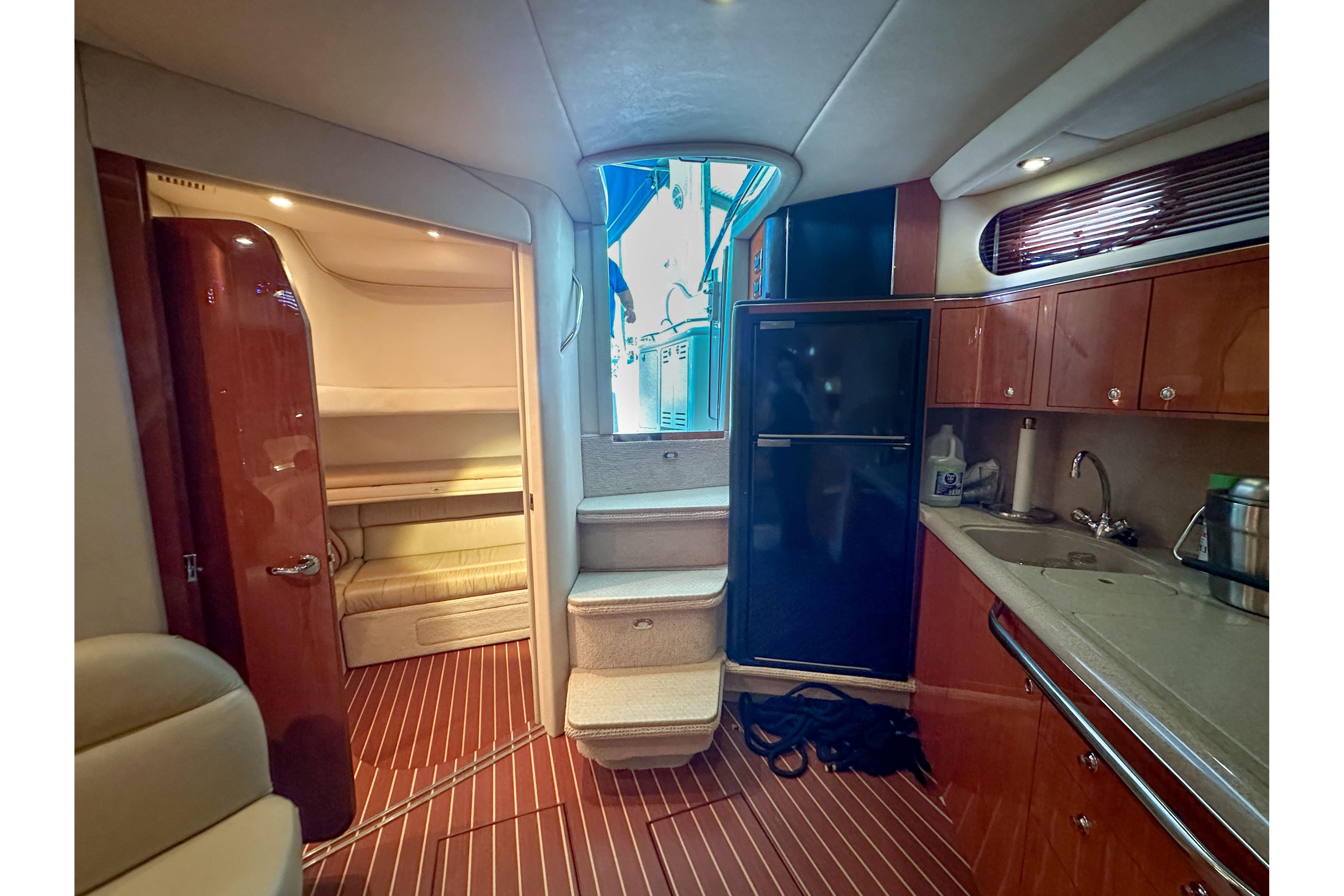 Interior of 2001 Sea Ray 410 Sundancer yacht with kitchenette and seating area.