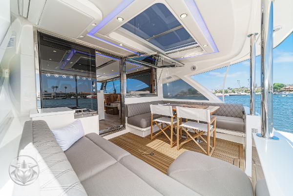 Luxurious interior of the 2025 Riviera 645 SUV yacht with waterfront view.