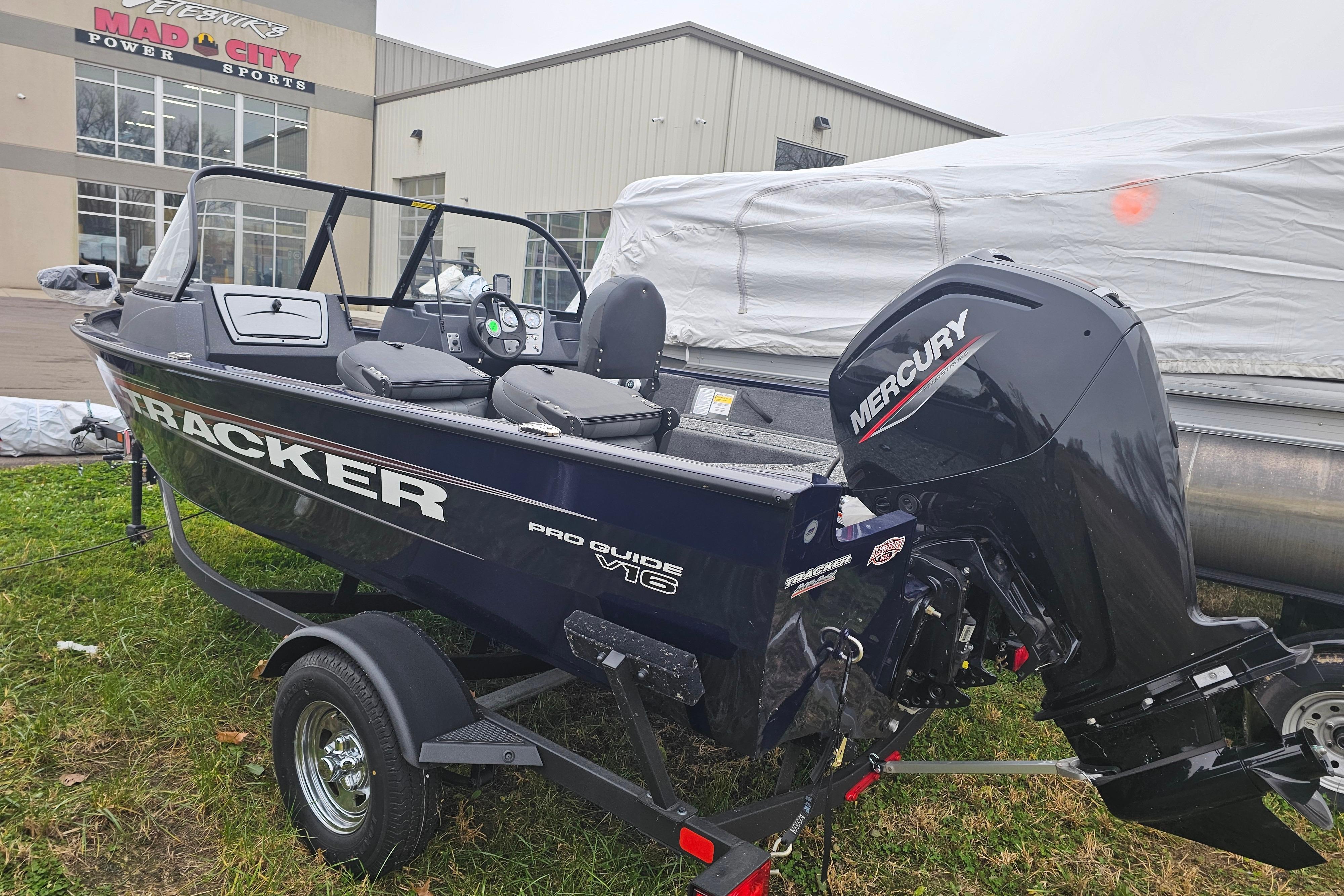2025 Tracker Pro Guide V-16 WT boat with Mercury engine at dealership.