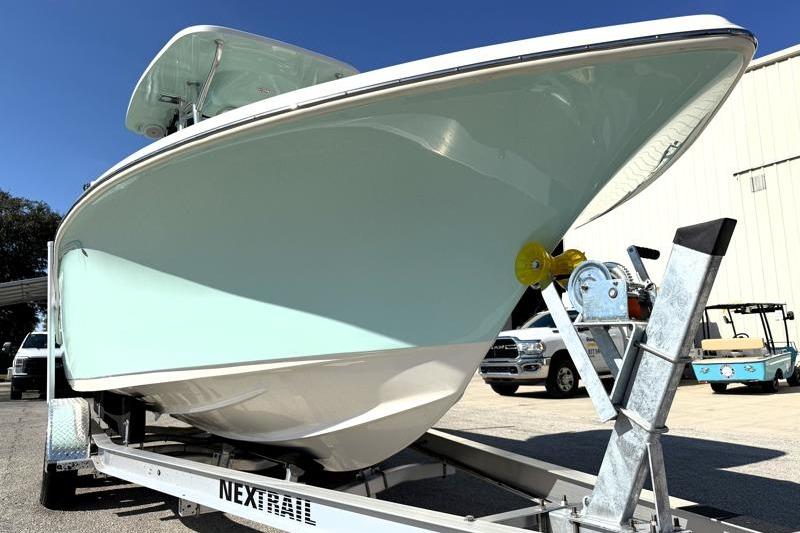 2025 Key West 239 FS boat on trailer, light blue hull, parked outdoors.