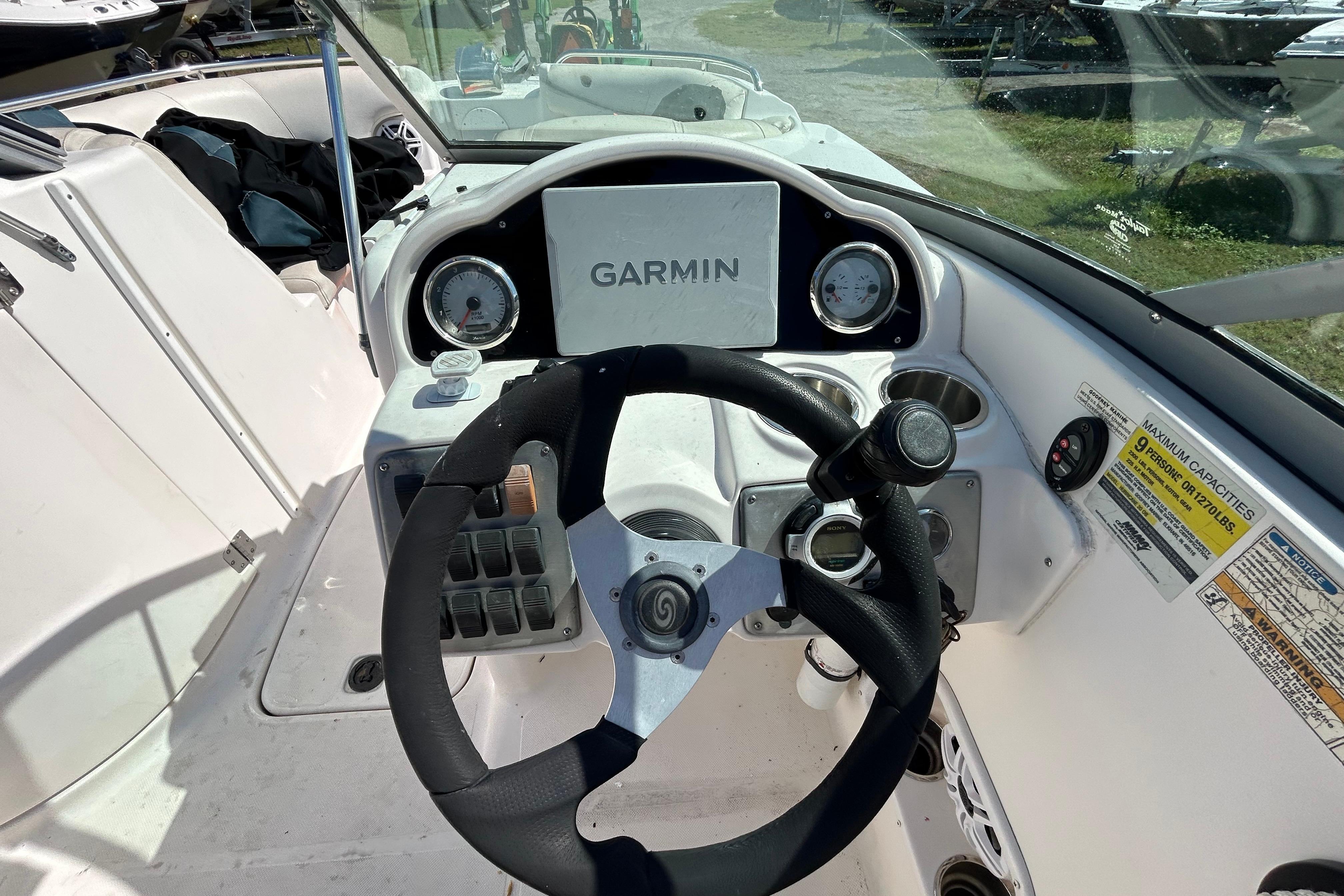 2011 Hurricane SunDeck 2000 OB boat dashboard with Garmin navigation system.