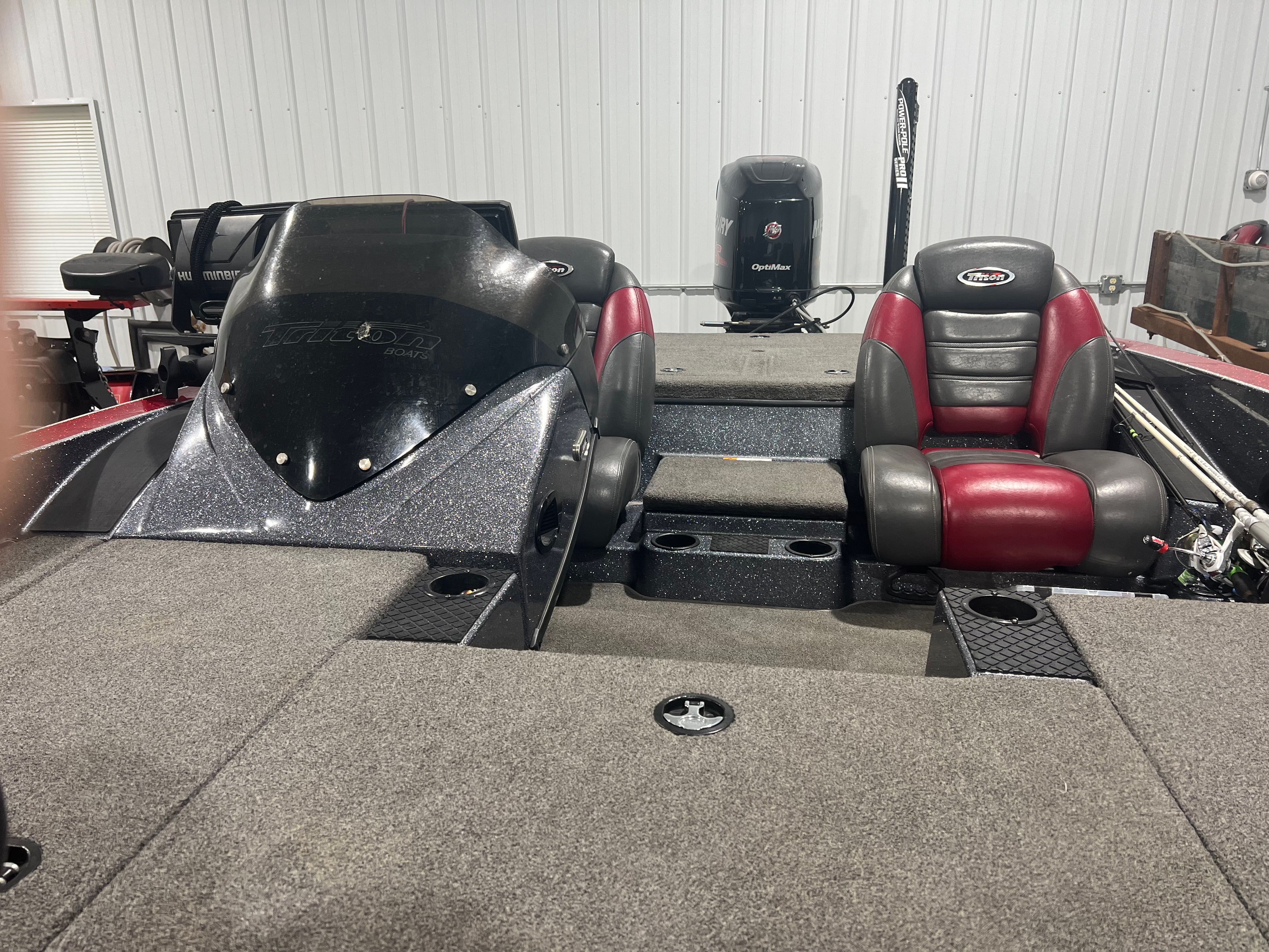 2015 Triton 18XS with gray and red interior, two seats, and fishing rod holders.