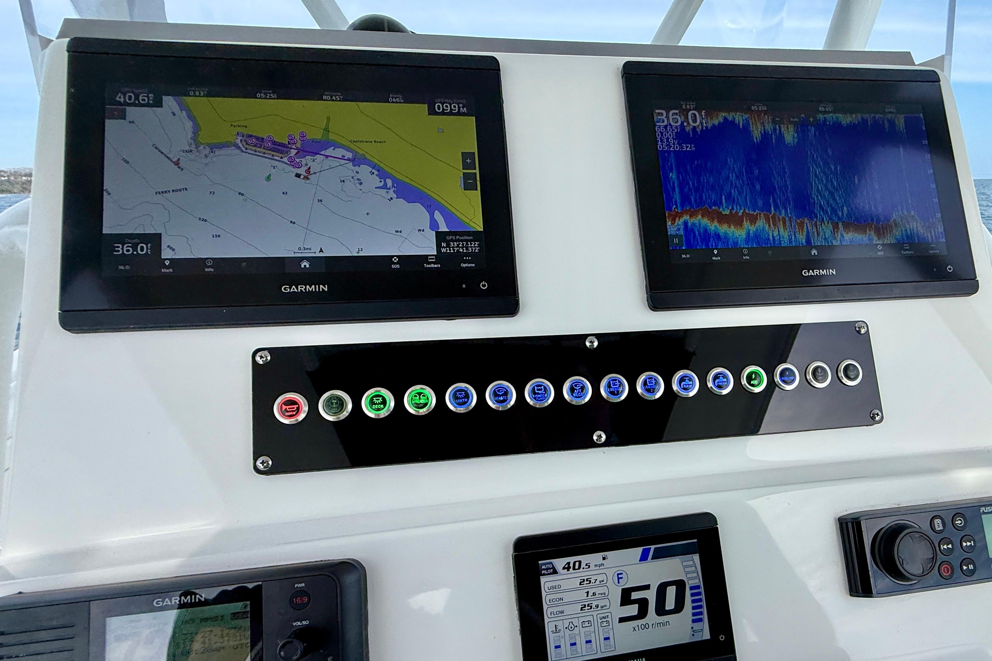 Edgewater 245CC 2023 boat dashboard with Garmin navigation and control panels.