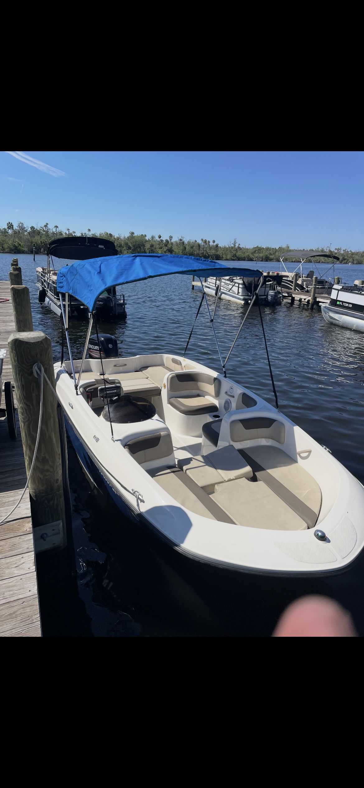 2018 Bayliner Element E18 at dock with blue sunshade.