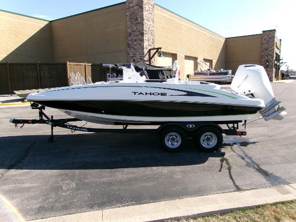 2024 Tahoe 2150 CC boat on trailer, parked outdoors near a building.