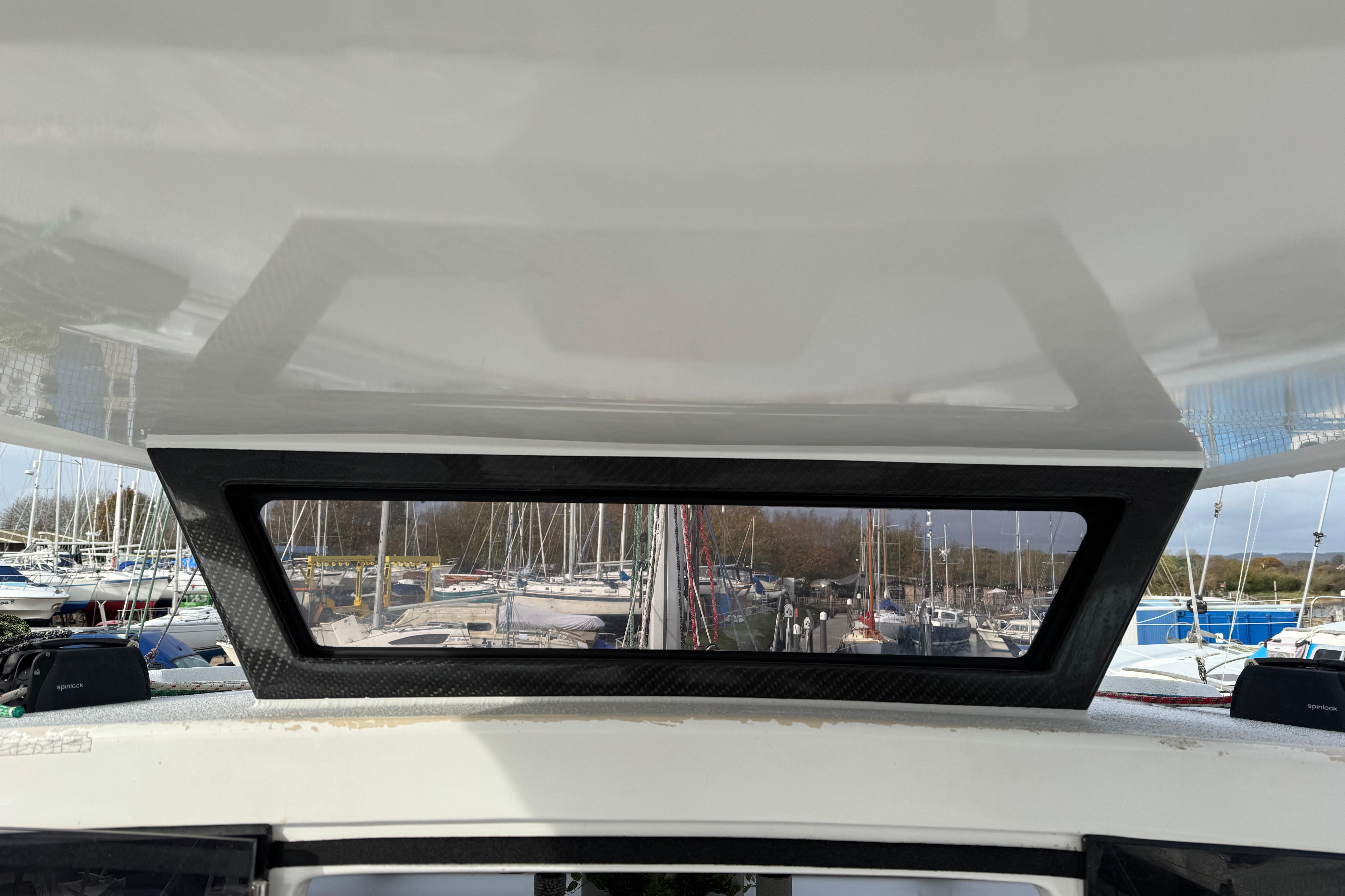 Dazcat 1195 catamaran interior view, showcasing sleek design and marina background, 2011 model.