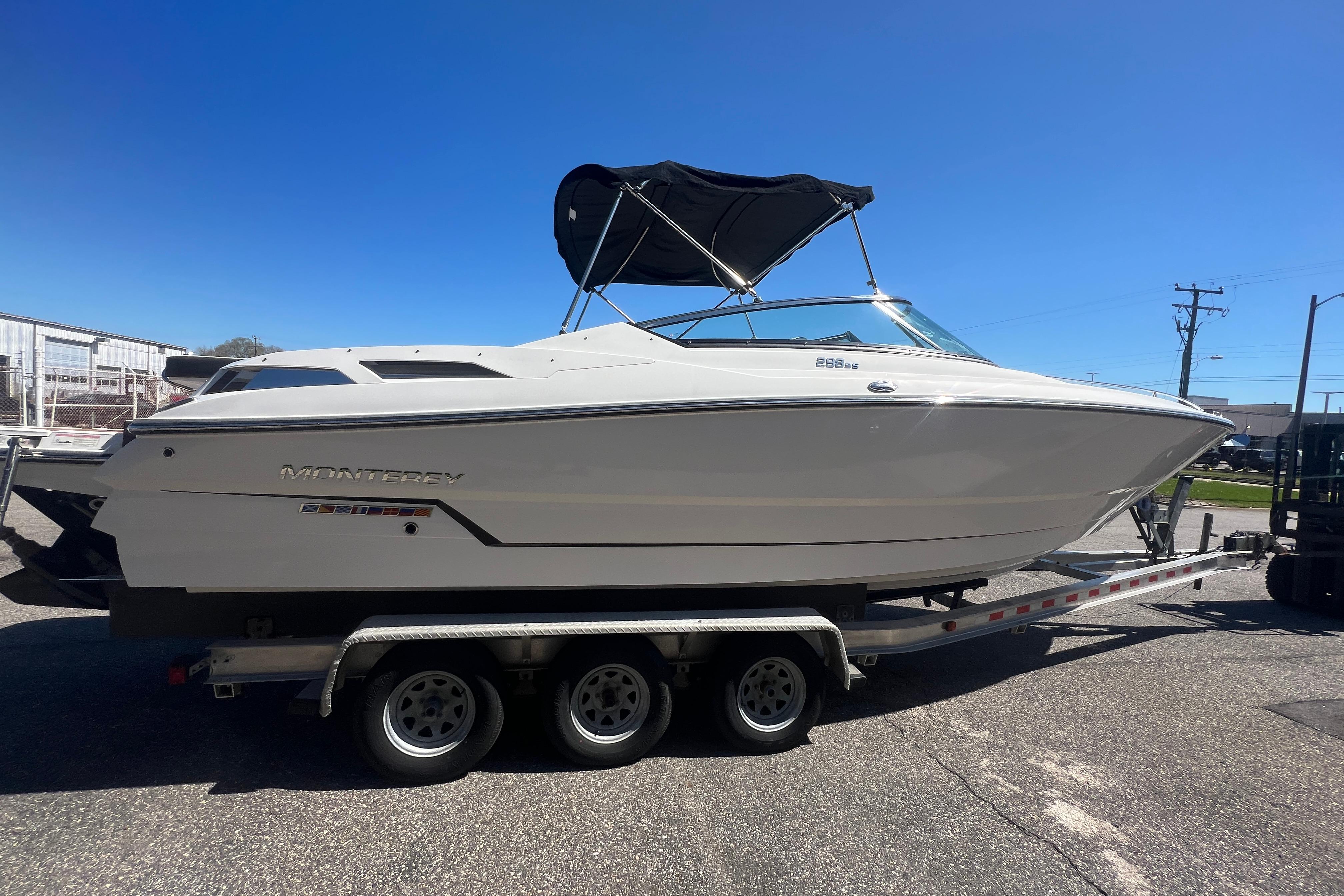 2017 Monterey 298SS Super Sport boat on trailer under clear blue sky.