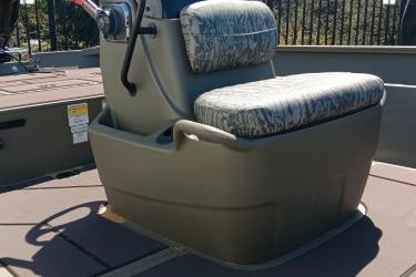 2026 Tracker Grizzly 2072 CC boat seat with steering console, featuring camouflage upholstery.