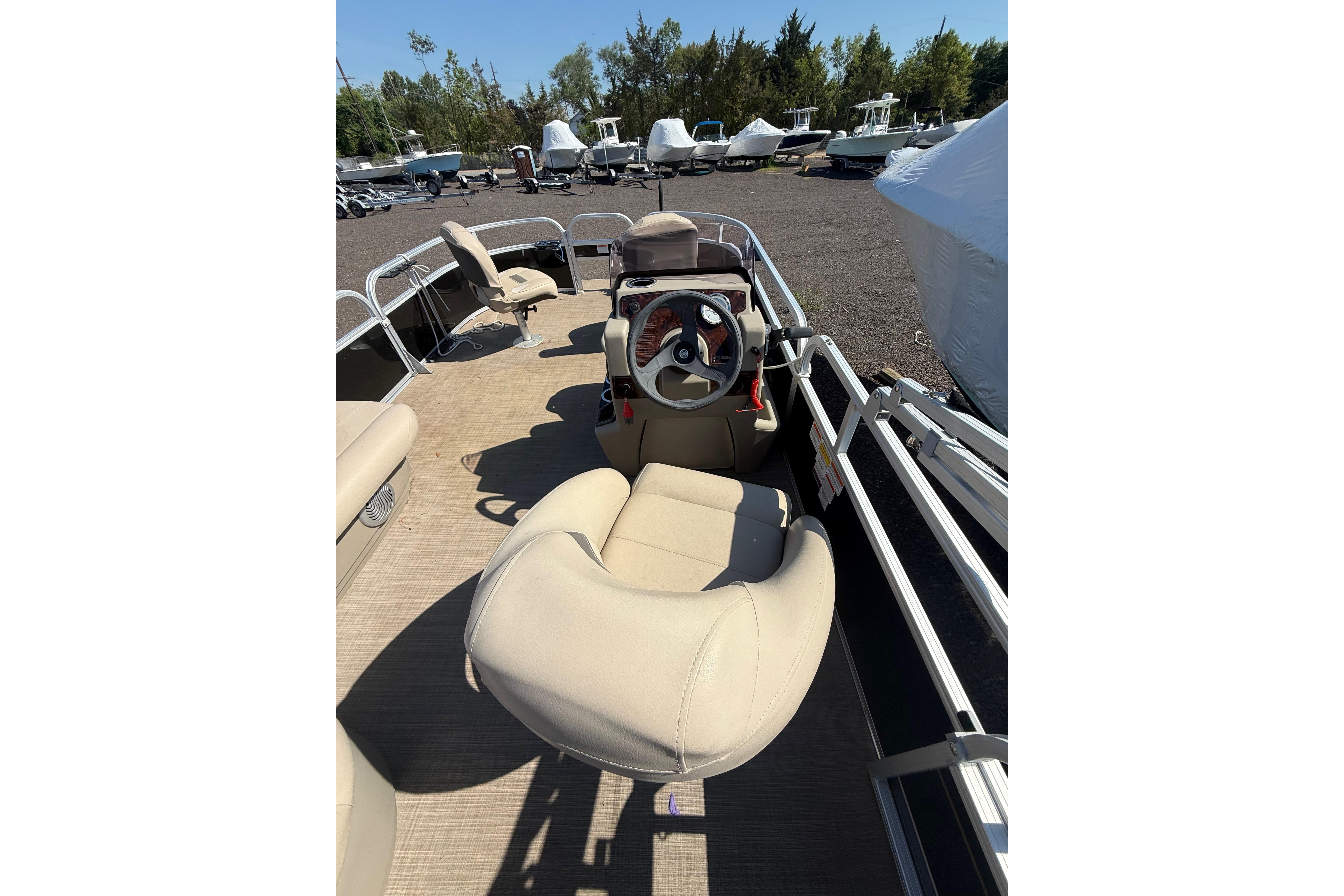 2021 Sun Tracker Bass Buggy 16 XL Select pontoon boat interior with beige seating.