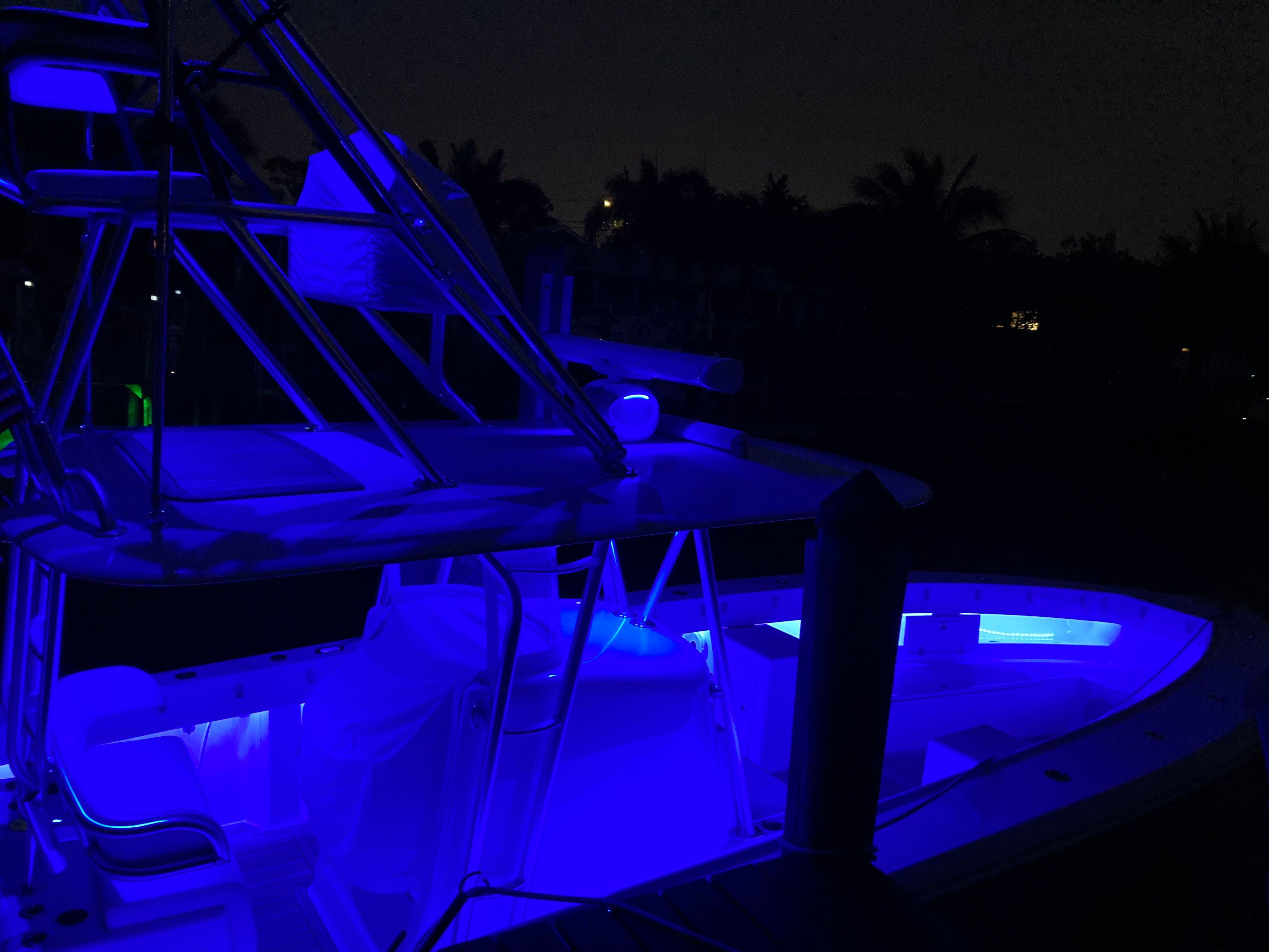 Venture CC 2019 boat with blue LED lighting at night.