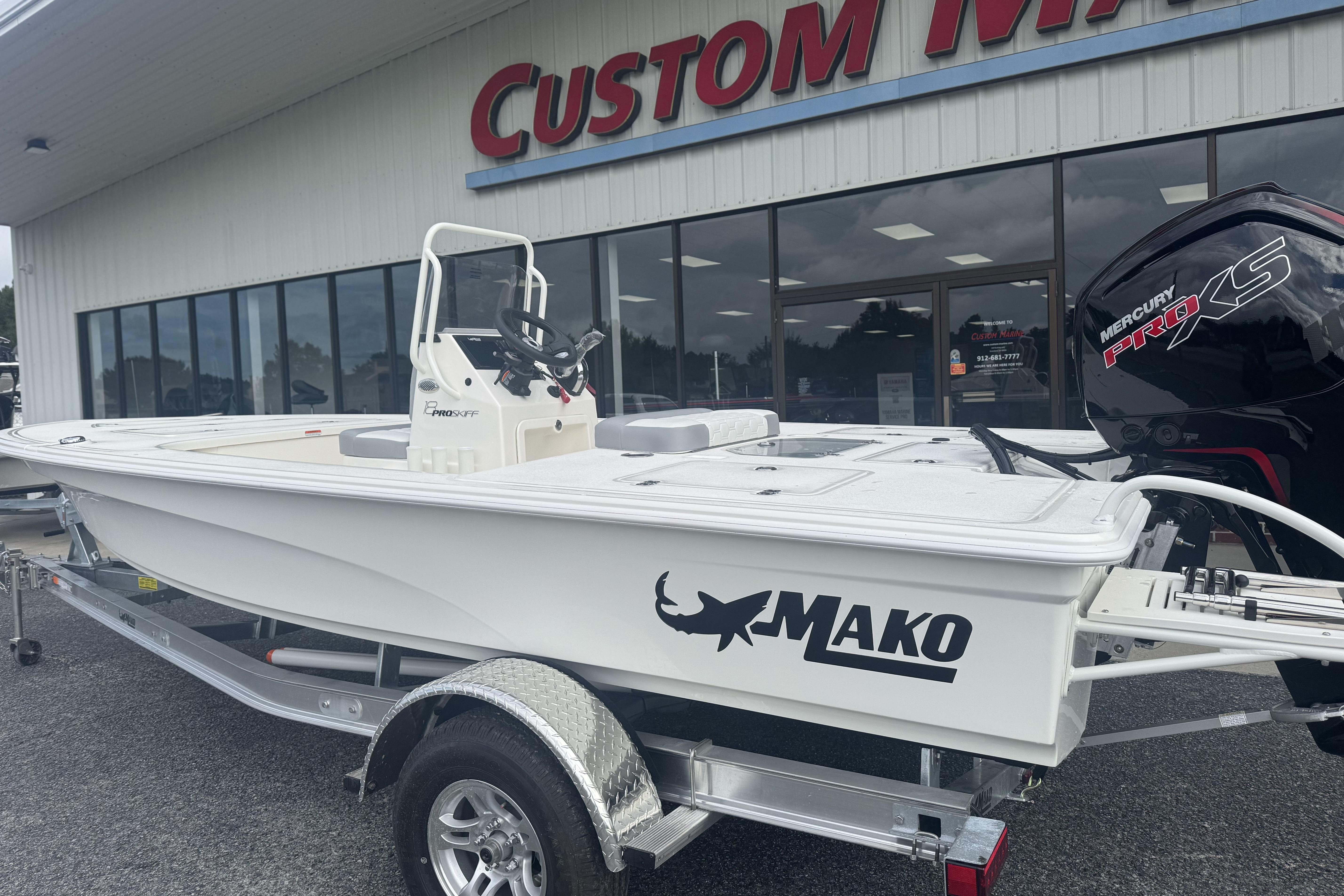 2026 Mako 18 Pro Skiff boat on trailer outside dealership.