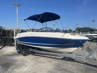2022 Bayliner VR6 boat on trailer with blue canopy in outdoor setting.