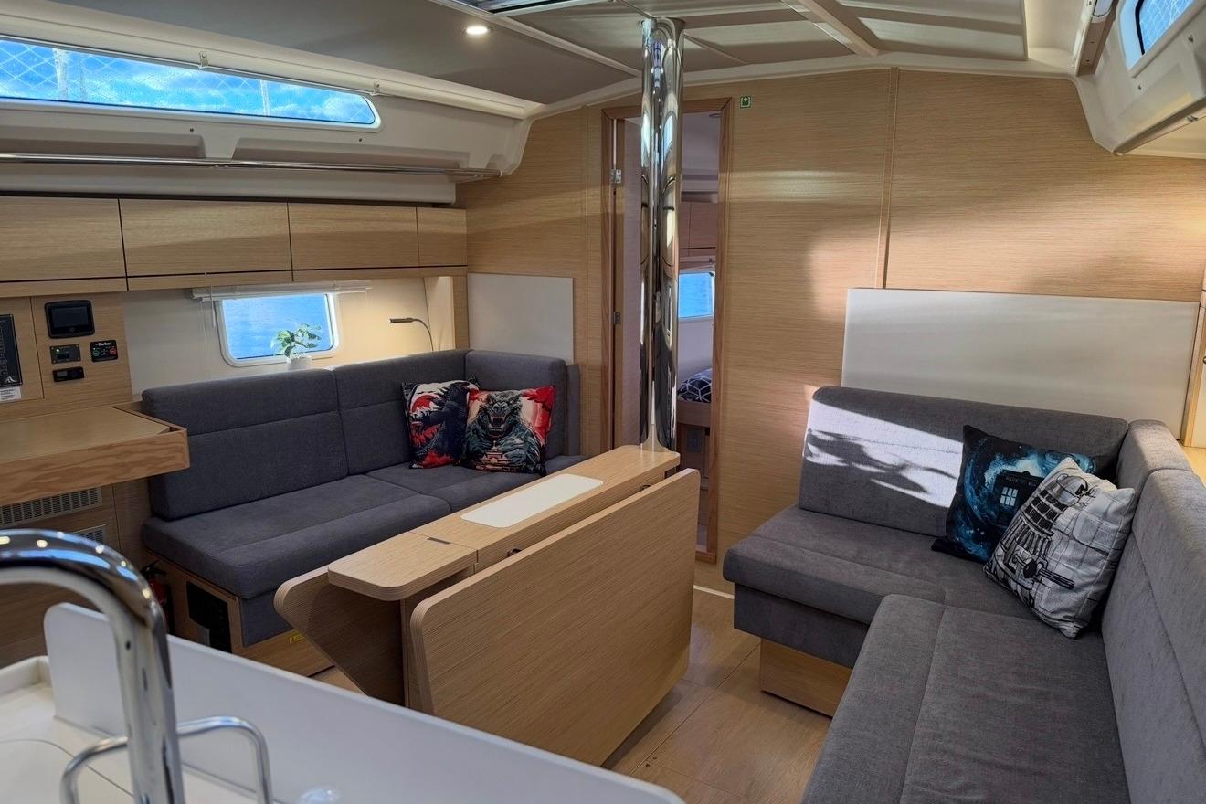 Interior of 2022 Hanse 418 yacht with modern seating and wooden finishes.