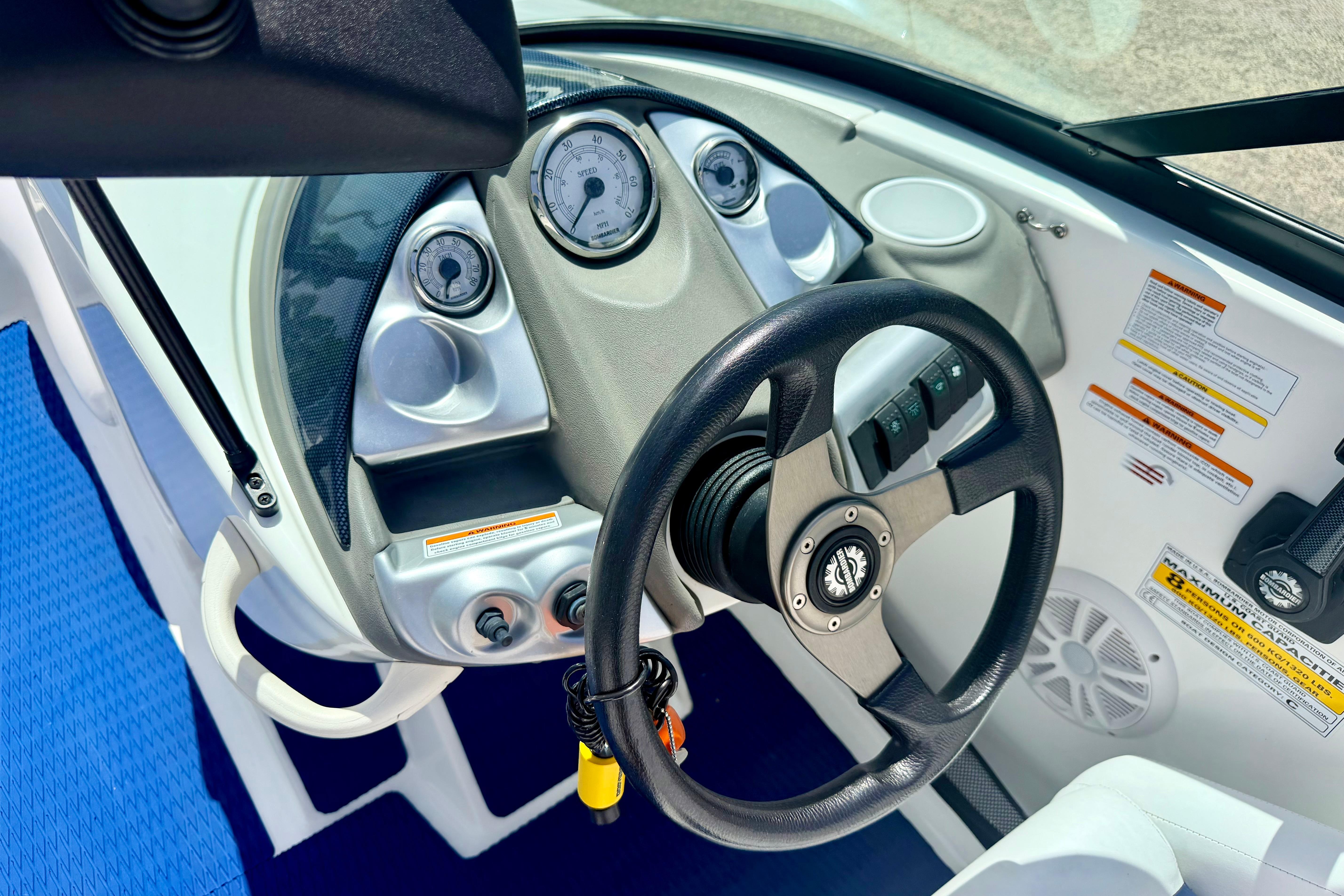 2004 Bombardier SEADOO Utopia 185 dashboard with steering wheel and gauges.