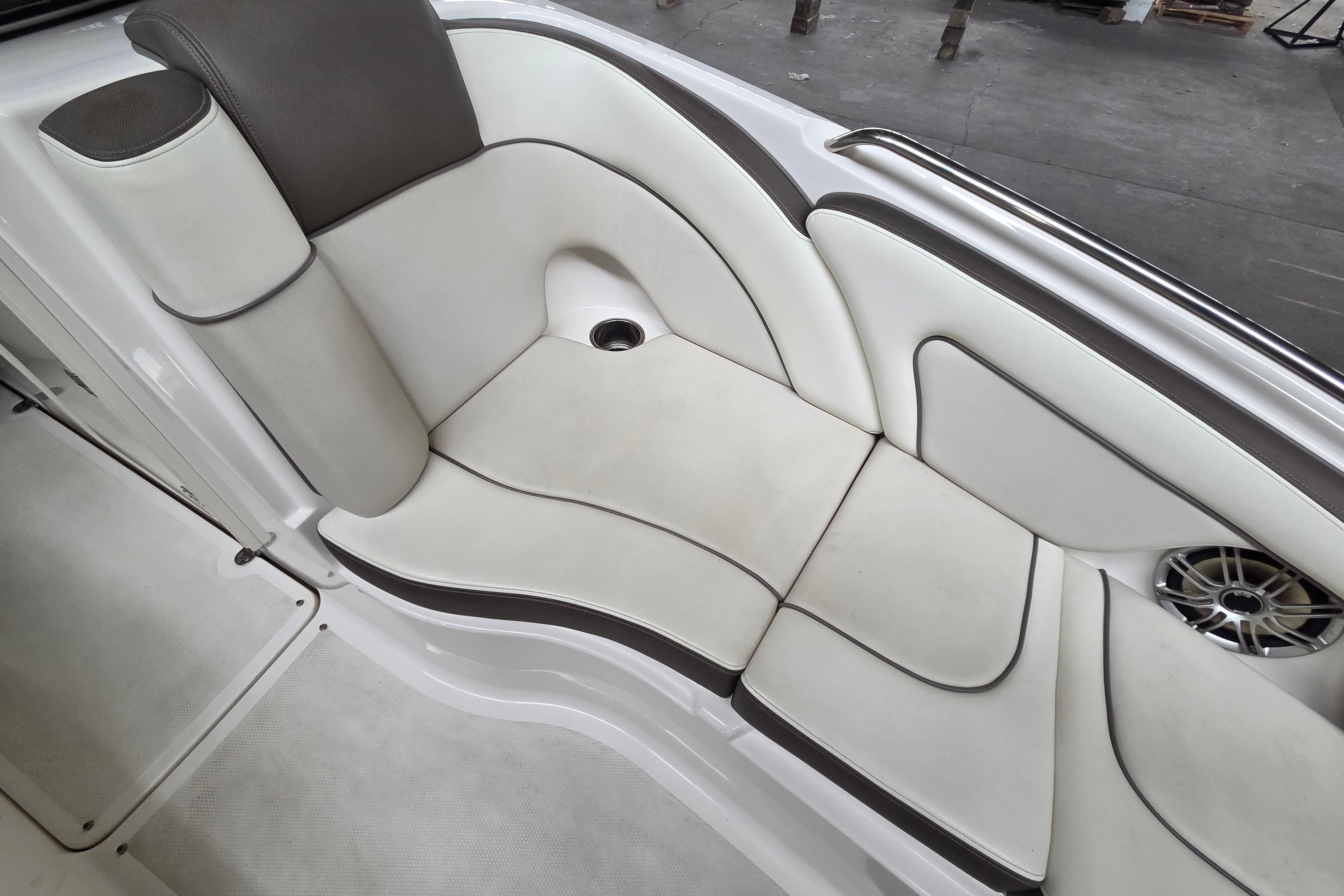 2013 Yamaha 242 Limited S boat interior with white and gray seating and speaker.