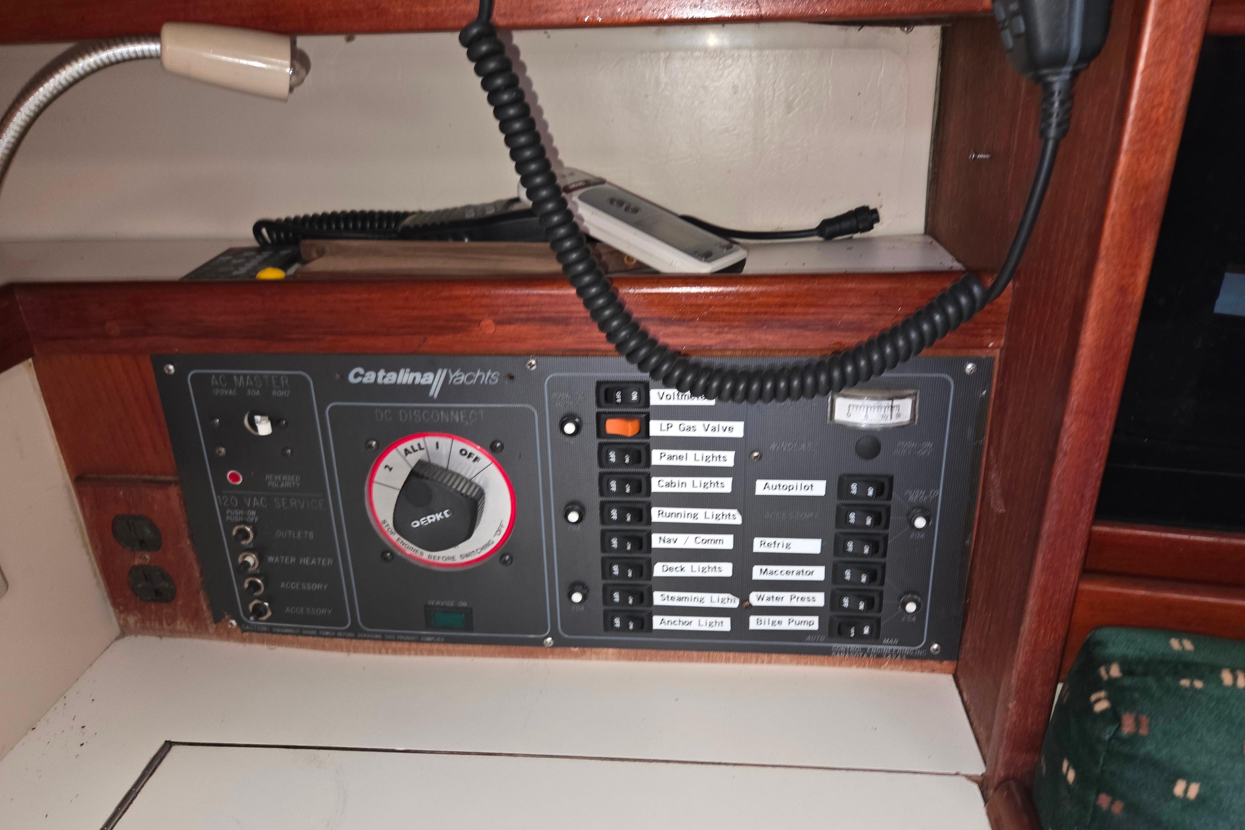 Electrical control panel of a 1986 Catalina 355 yacht with various switches and dials.