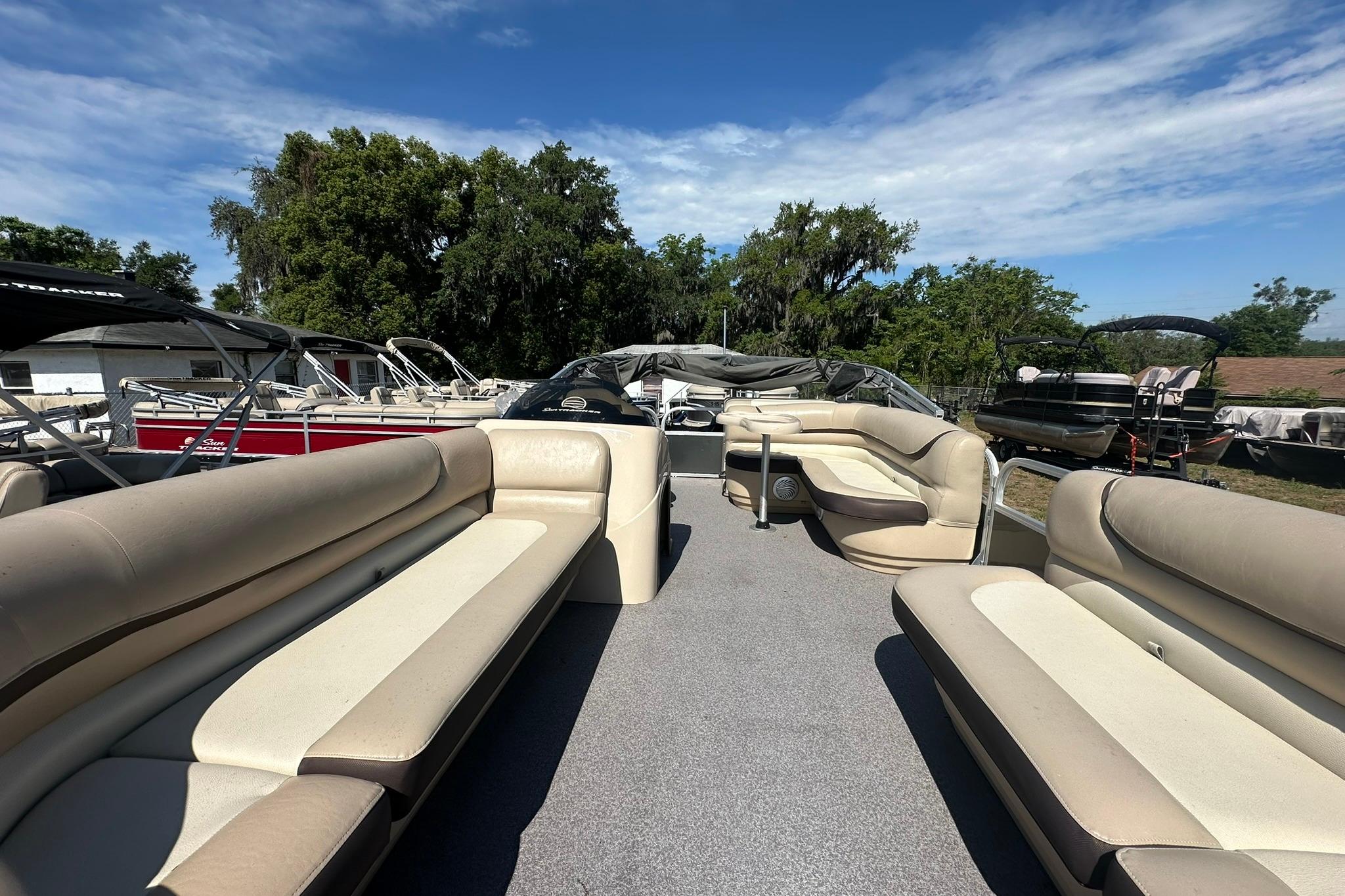 2016 SUNTRACKER Party Barge 20 pontoon boat with spacious seating and outdoor setting.
