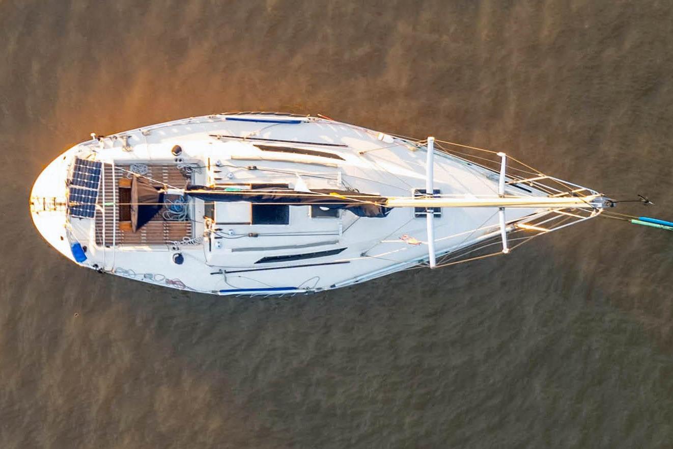 Aerial view of 1981 Beneteau First 32 sailboat on calm water.