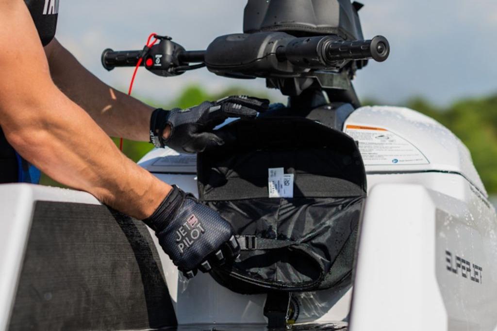 2025 Yamaha WaveRunner SuperJet with storage compartment open, showcasing Jet Pilot gloves.