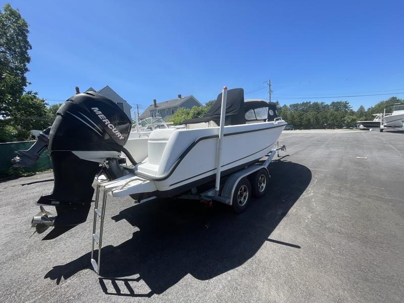 2006 Boston Whaler 210 Outrage boat on trailer with Mercury outboard motor.