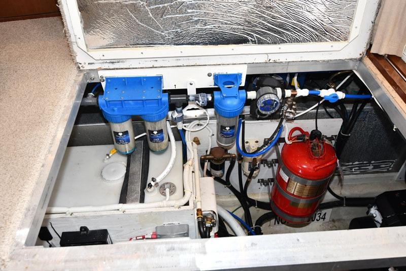 Engine compartment of a 2008 Carver 43 Super Sport with water filters and fire extinguisher.