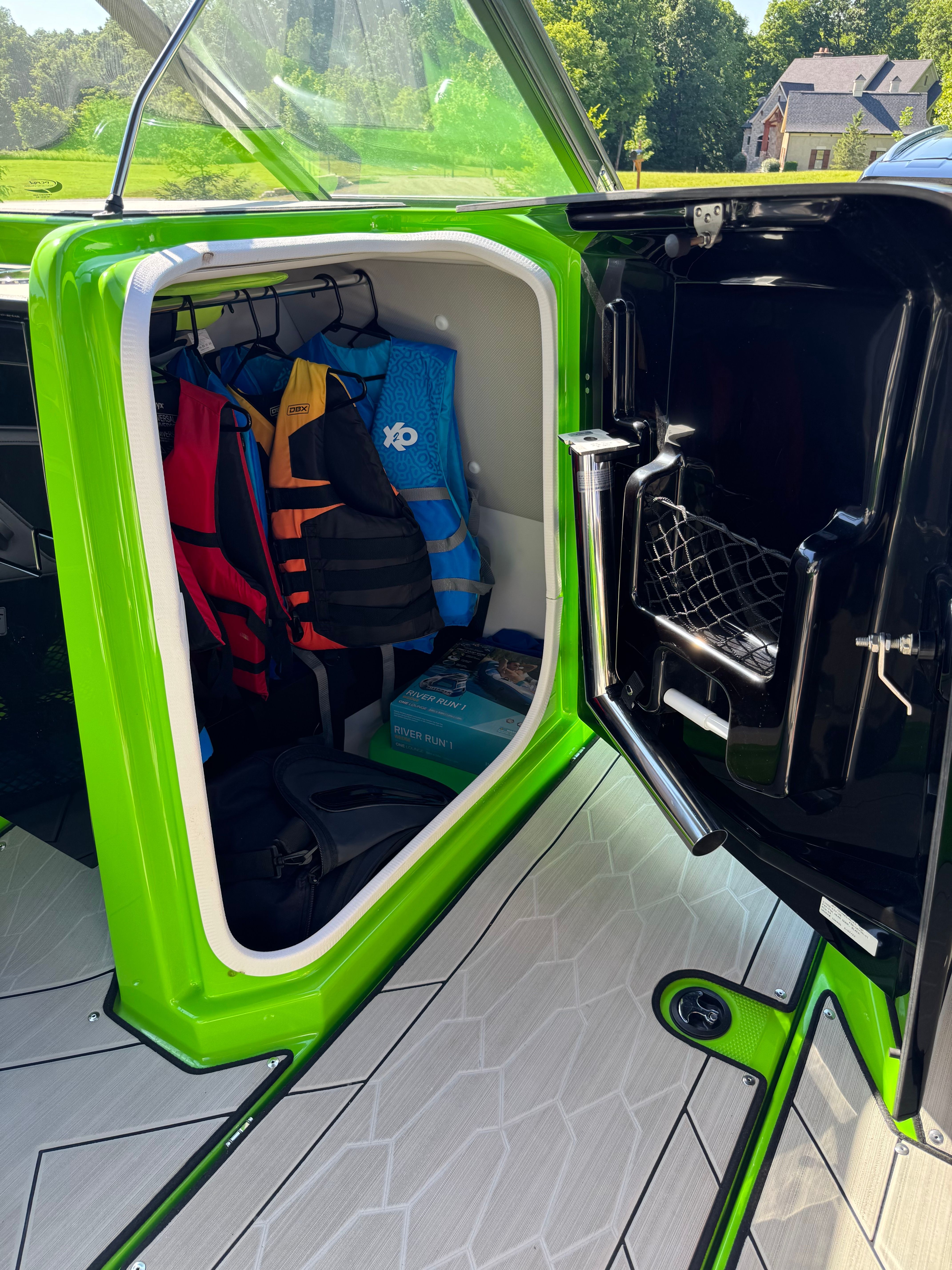Storage compartment in Yamaha 255XD with life jackets and accessories.