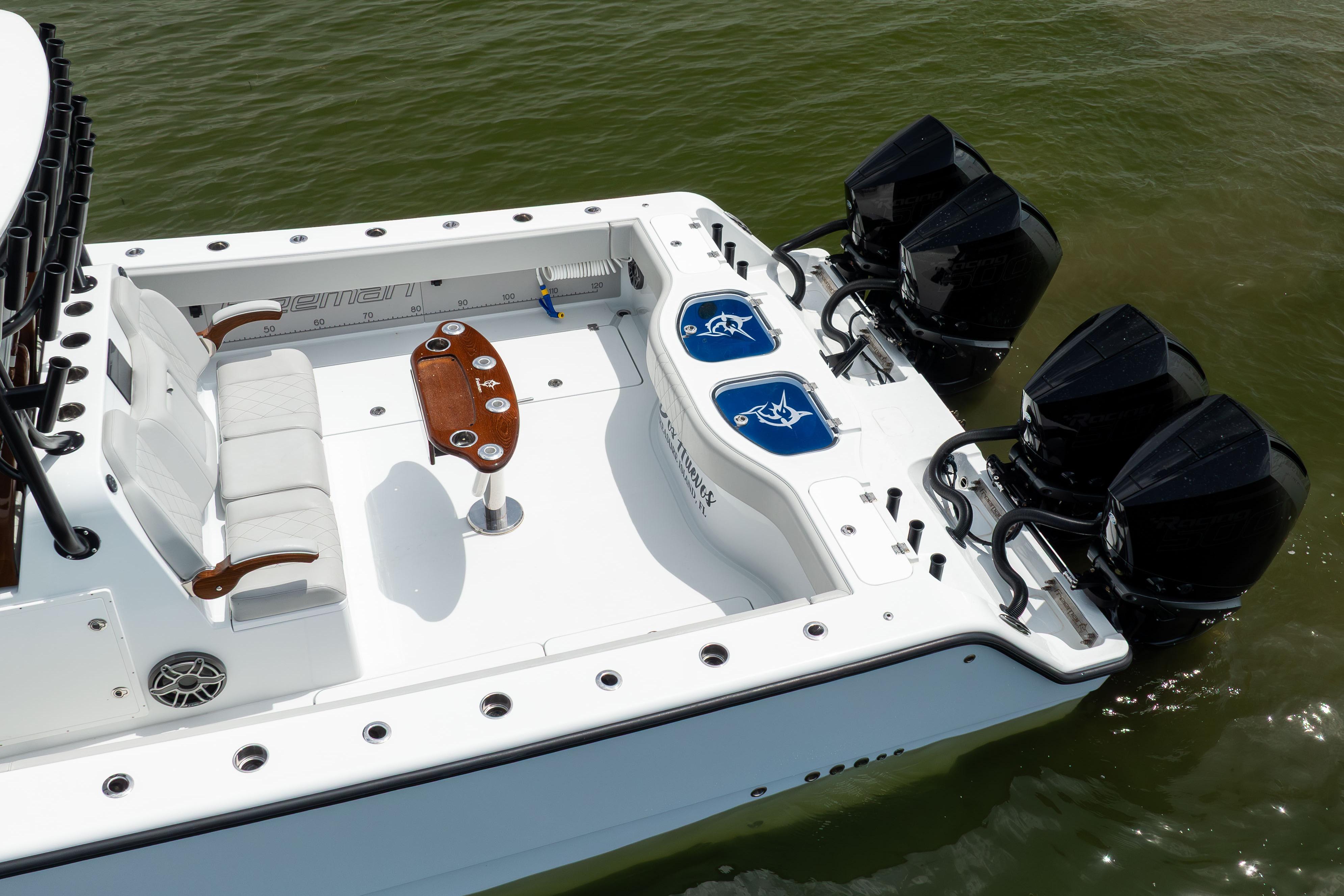 Freeman 42 LR 2025 boat with four engines and spacious deck in water.