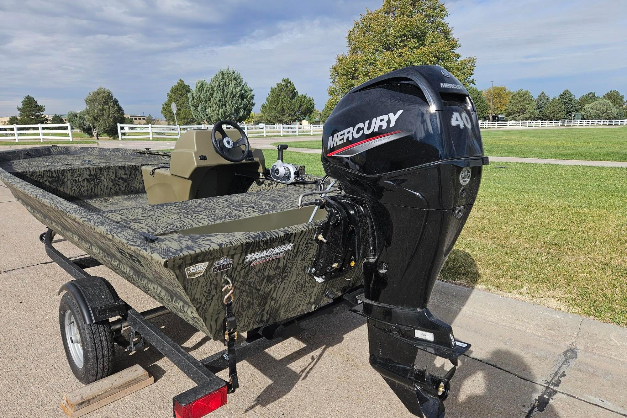 2026 Tracker Grizzly 1648 SC boat with Mercury 40 engine on trailer, outdoors.