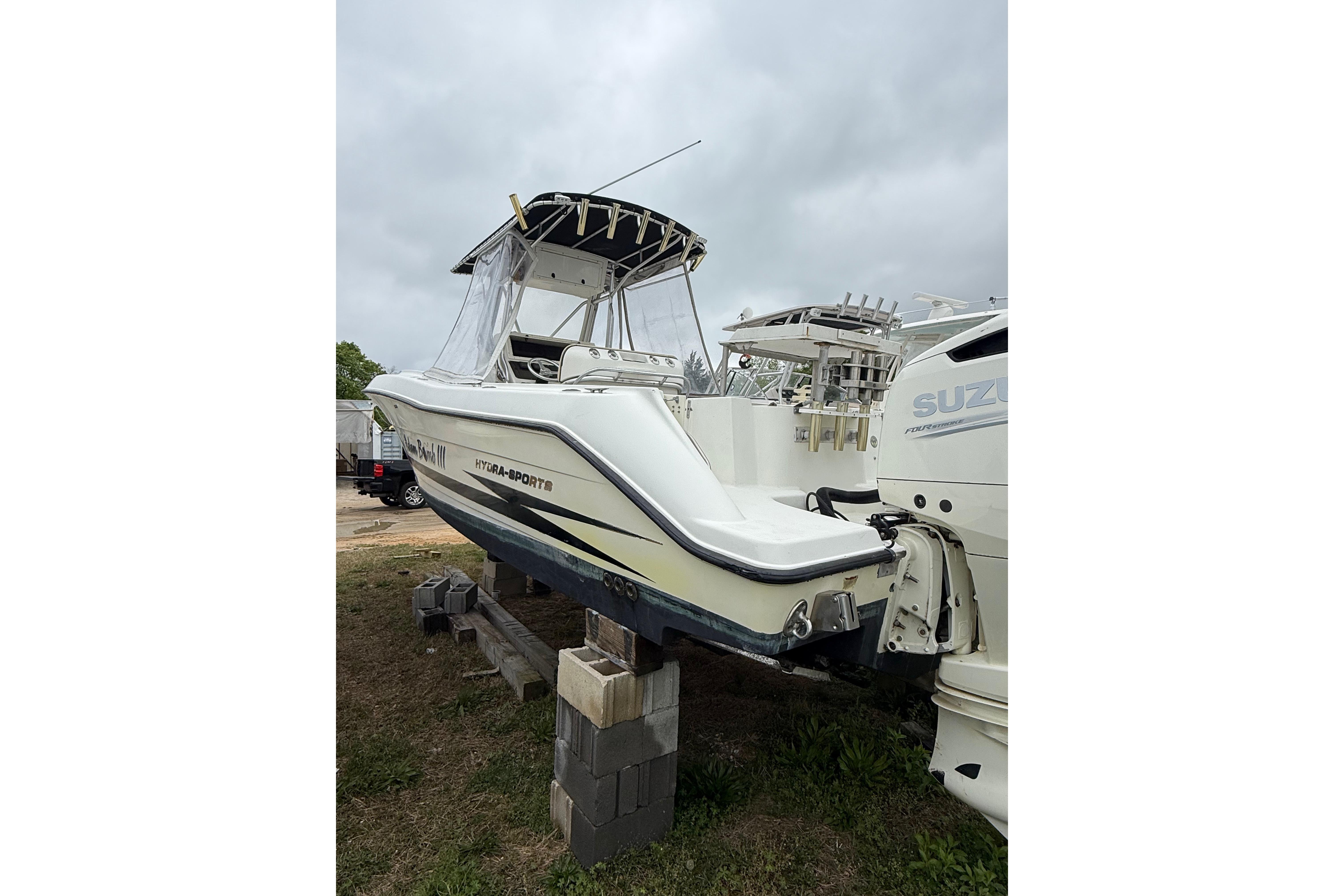 2003 Hydra-Sports Vector 2800 CC boat on blocks, overcast sky background.