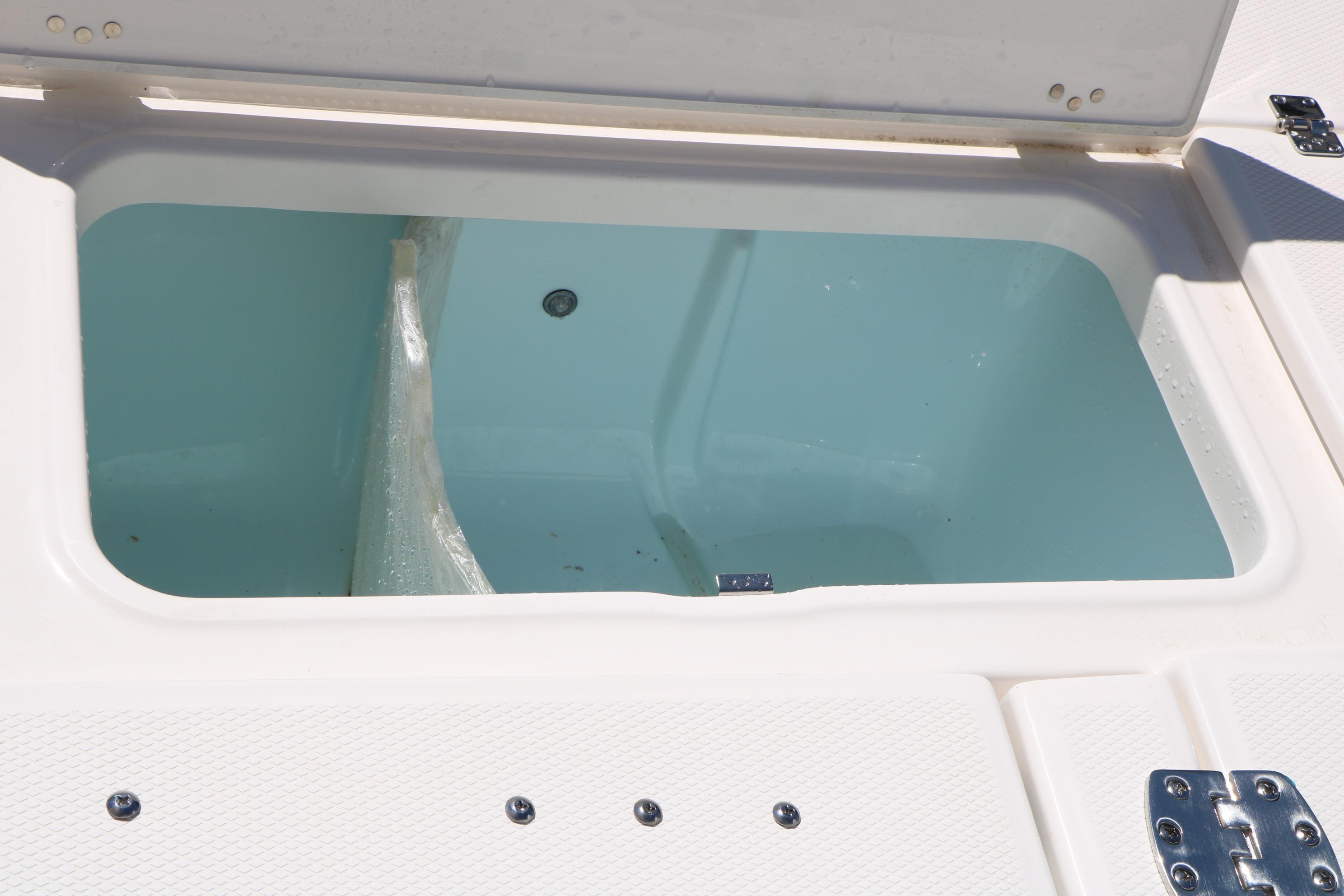 Livewell compartment on 2026 Robalo 246 Cayman boat, open lid view.