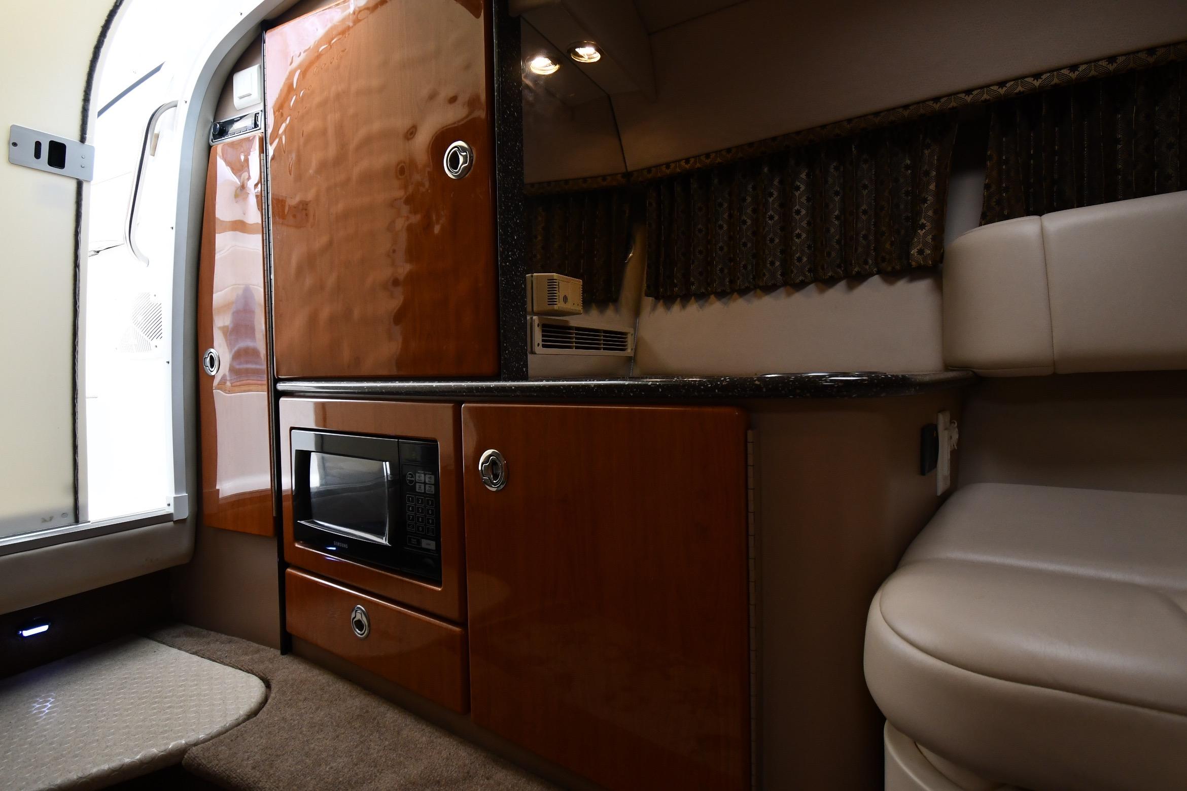 Interior of a 2004 Formula 330 Sun Sport boat with microwave and seating area.