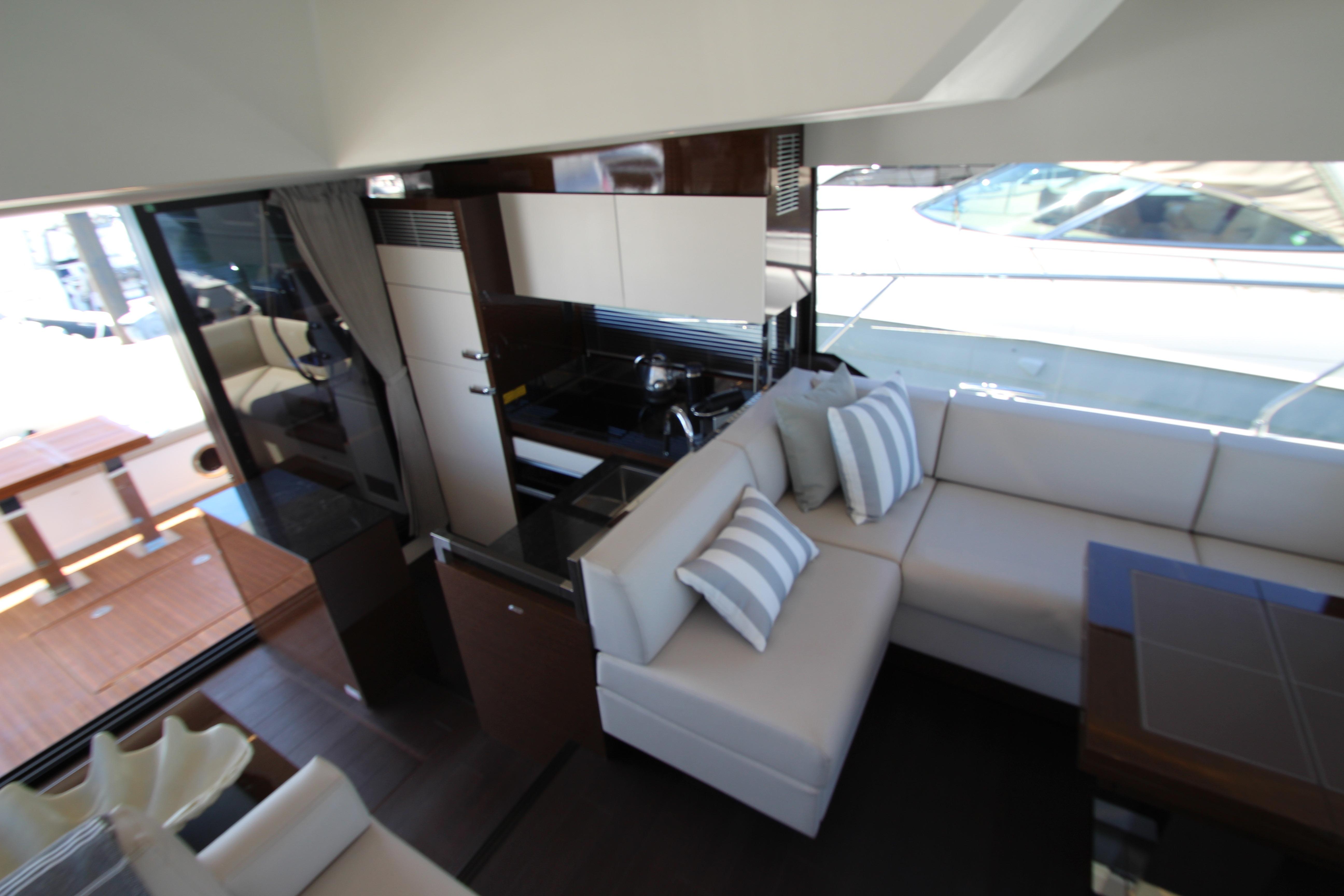 Luxurious interior of 2022 Prestige 520 yacht with modern kitchen and comfortable seating.