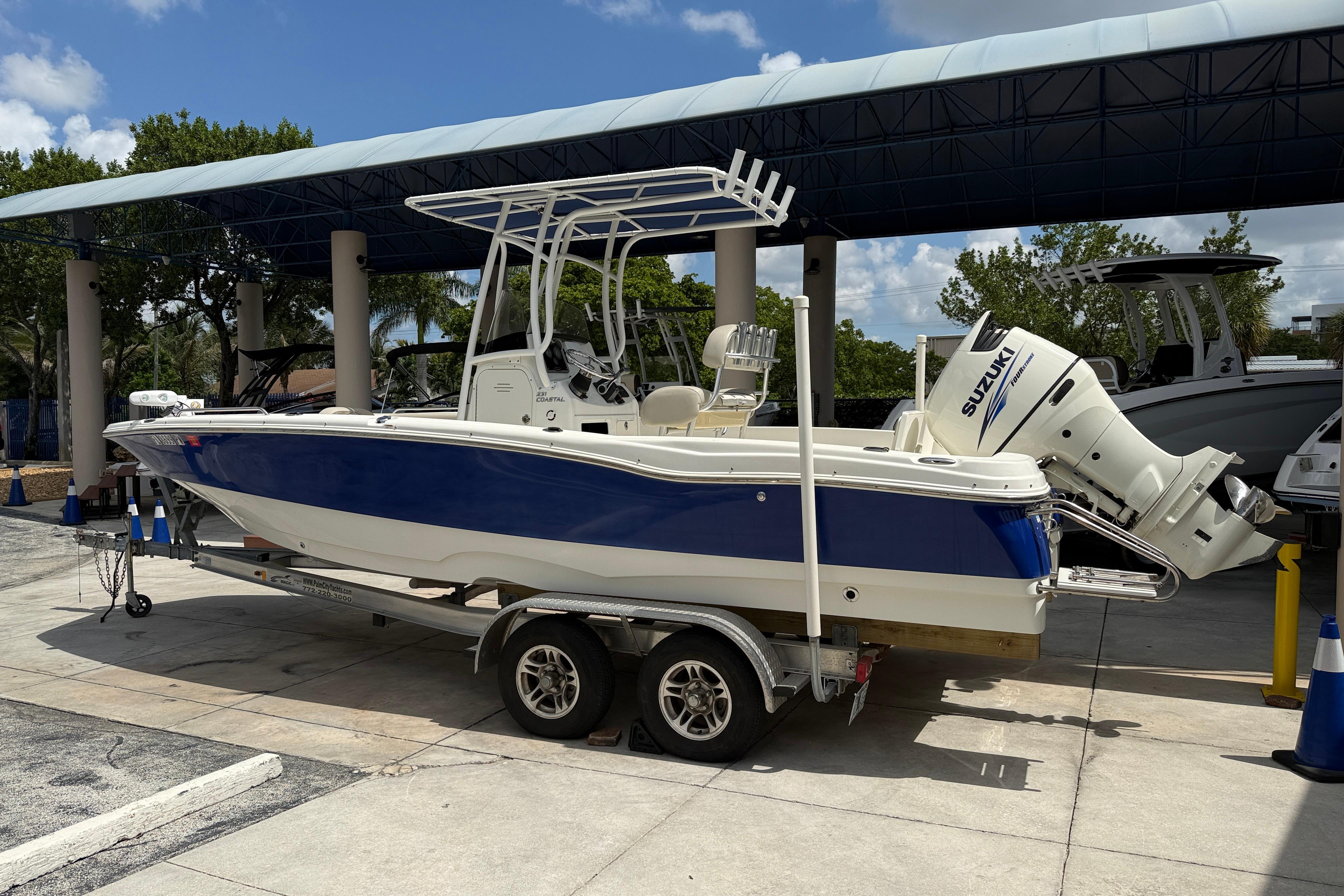 2015 NauticStar 231 Coastal boat on trailer with Suzuki outboard motor.