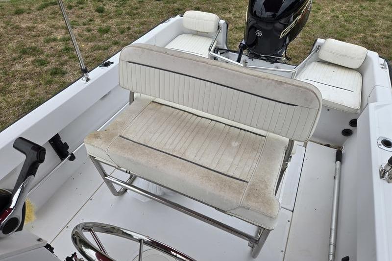 1996 Boston Whaler Outrage 17 boat interior with seating and steering wheel.