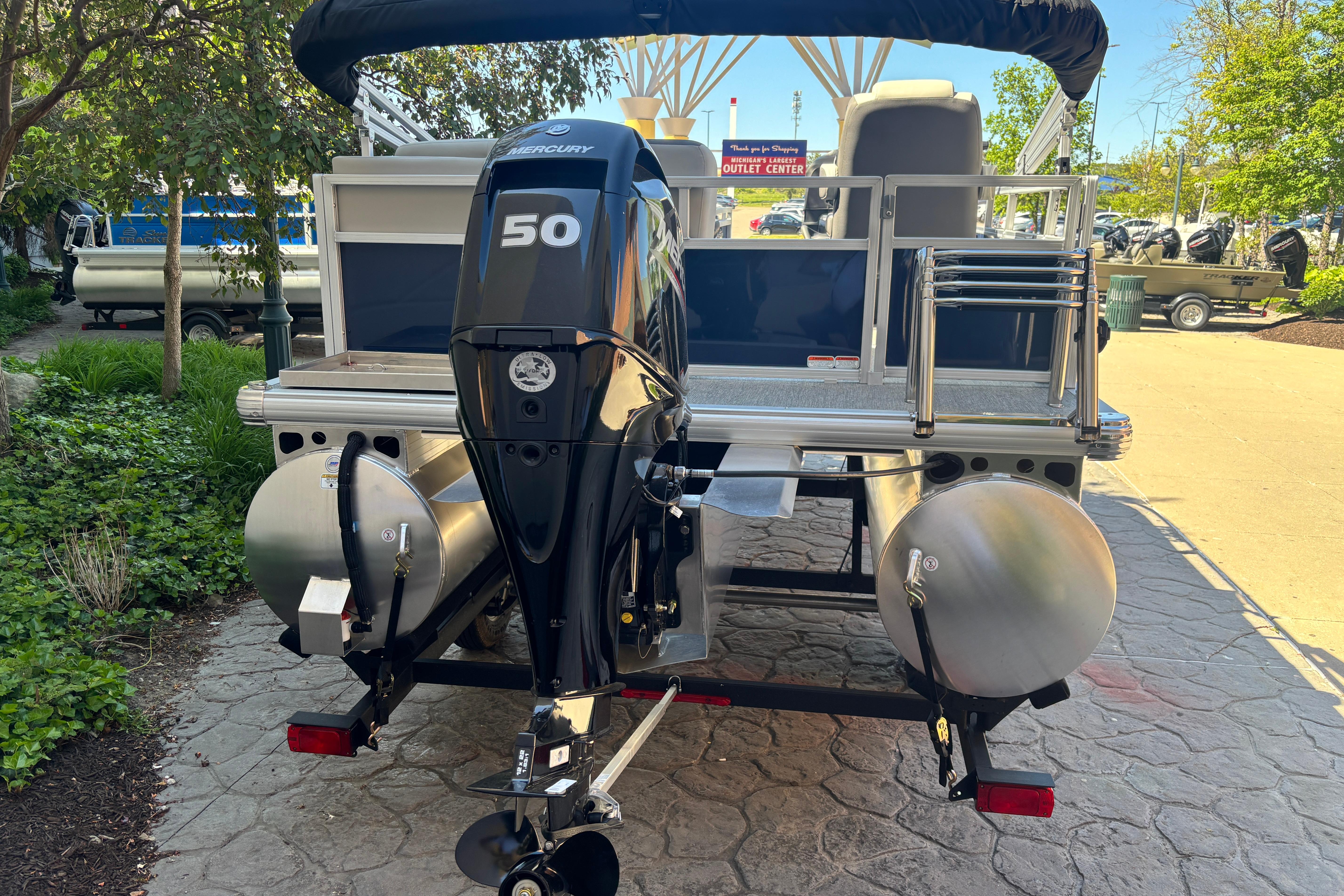 2026 Sun Tracker Bass Buggy 16 XL Select pontoon boat with Mercury 50 engine, rear view.