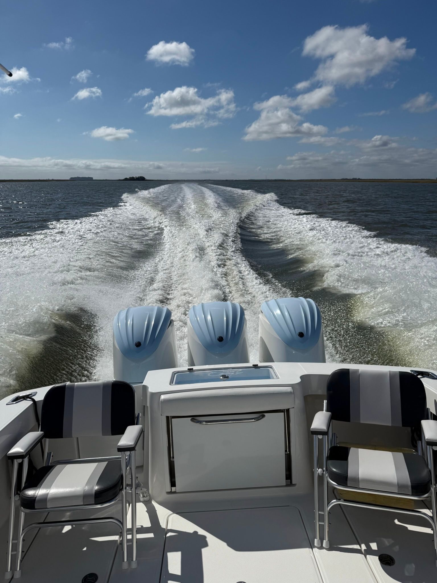 The image shows the stern of an Albemarle 30 Express boat with three engines on the water.
