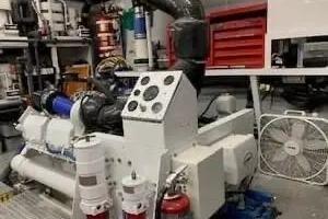 Engine room of 1997 Broward raised pilot house M/Y with machinery and tools.
