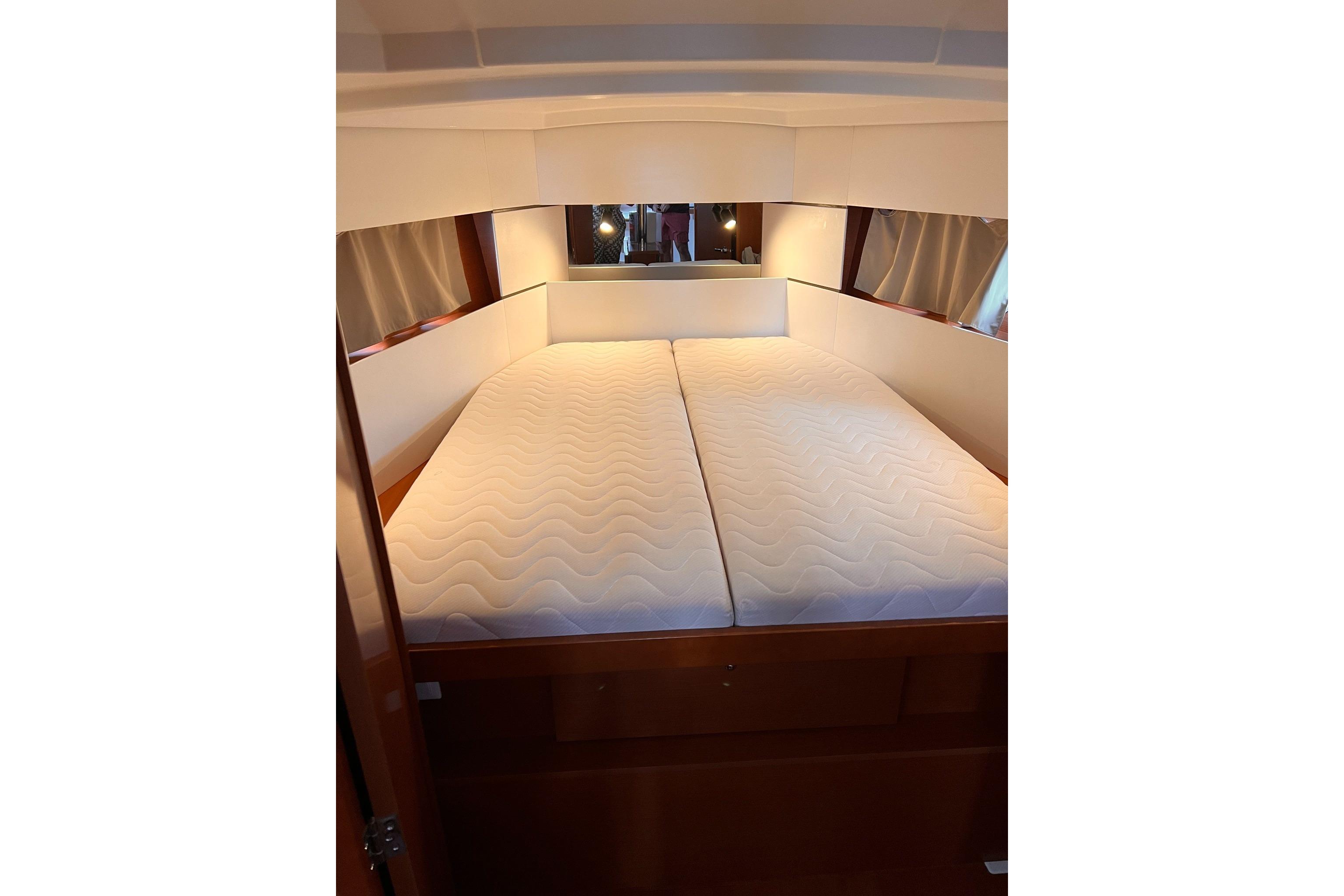 2017 Beneteau Oceanis 38.1 yacht cabin with double bed and wooden interior.